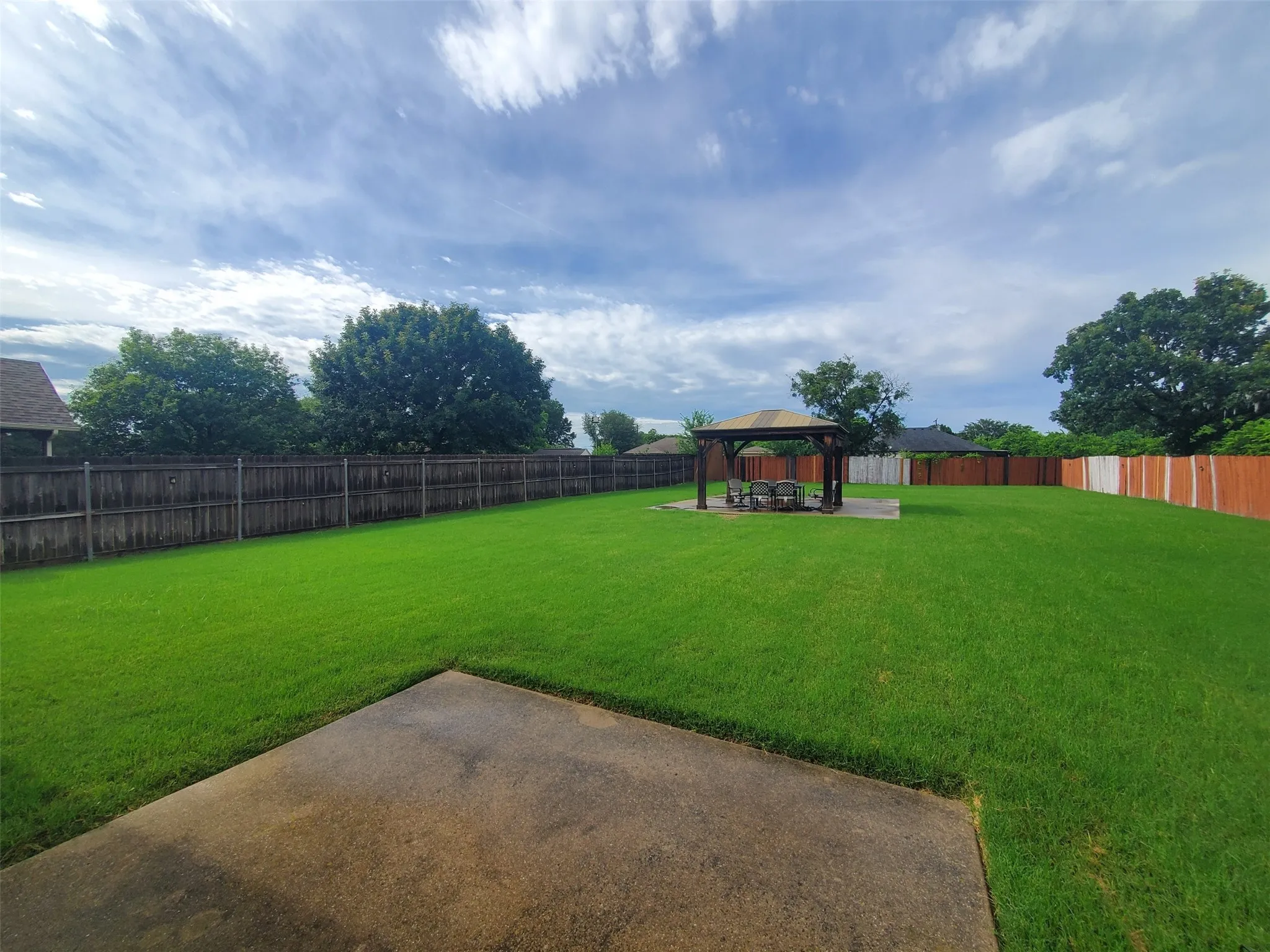 Backyard showing patio and gazebo.