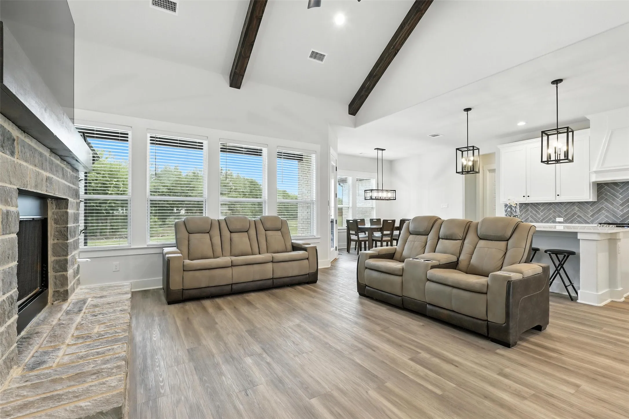 Expansive living area with high vaulted ceilings and exposed wood beams