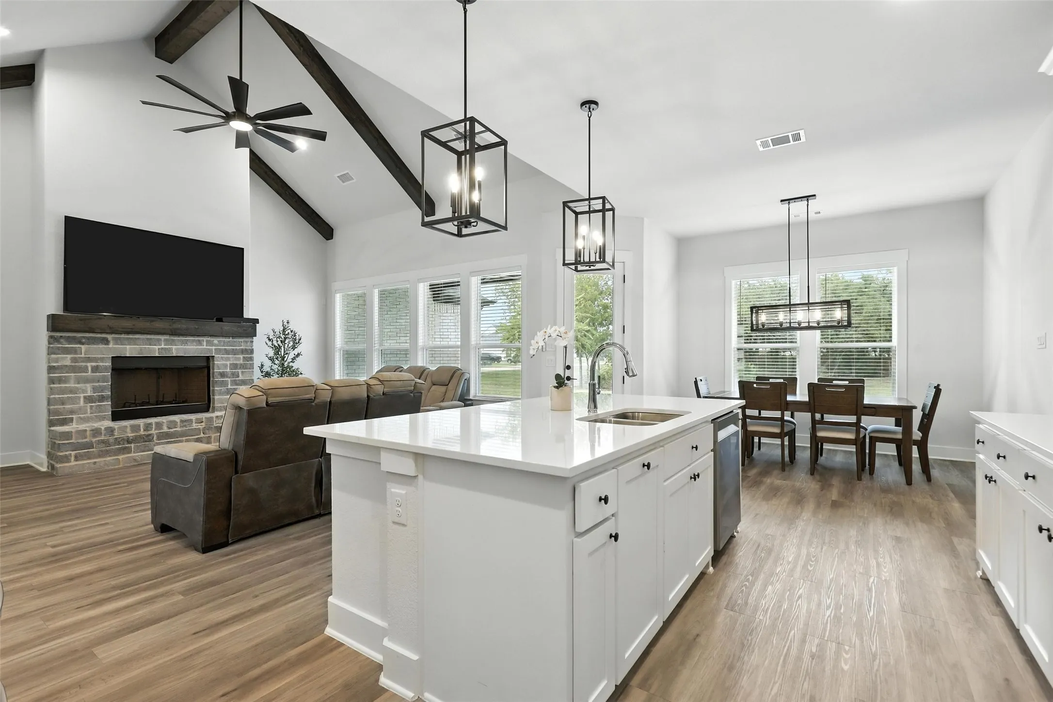 Open-concept living space featuring wood-finish flooring throughout