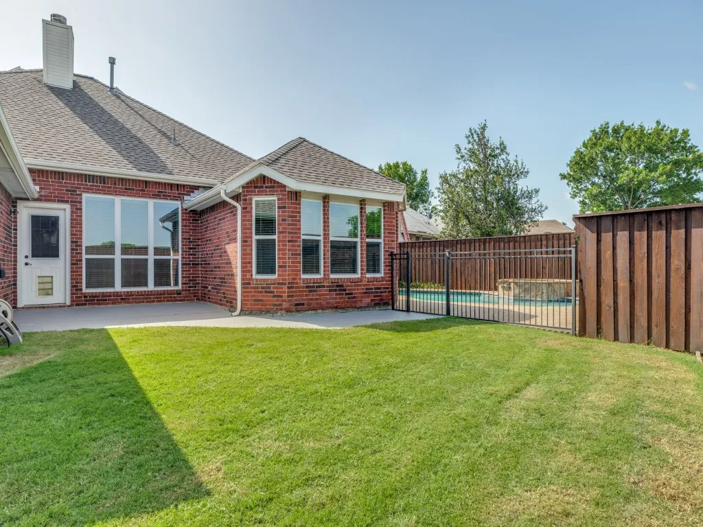 Nice Backyard with view of pool.  Wrought Iron Fence to keep the pets and small children away from pool until adults can supervise