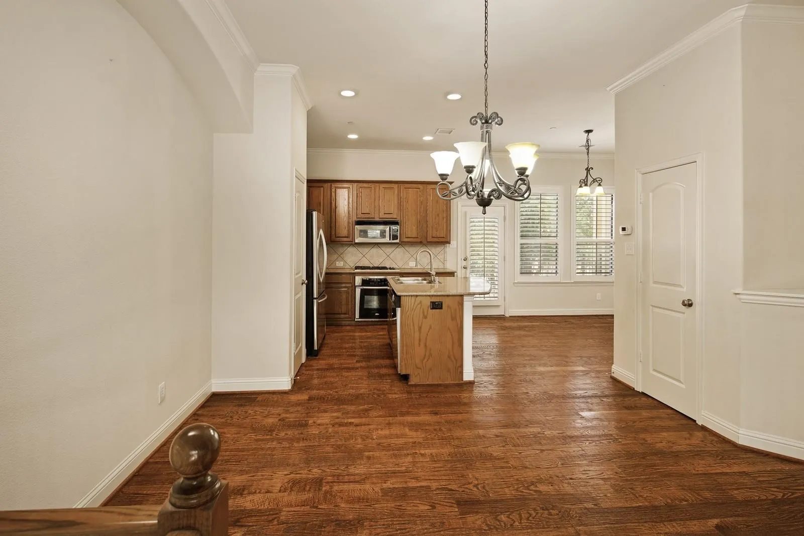 Open-concept living space with wood-finish flooring throughout