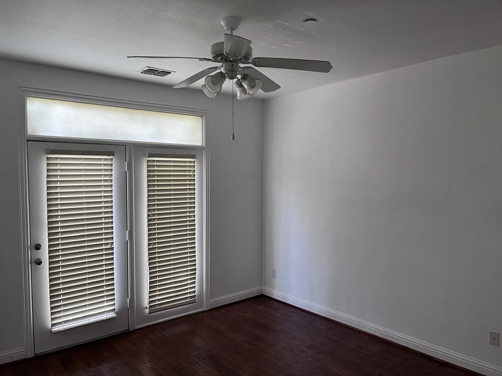 French doors with integrated blinds and a transom window