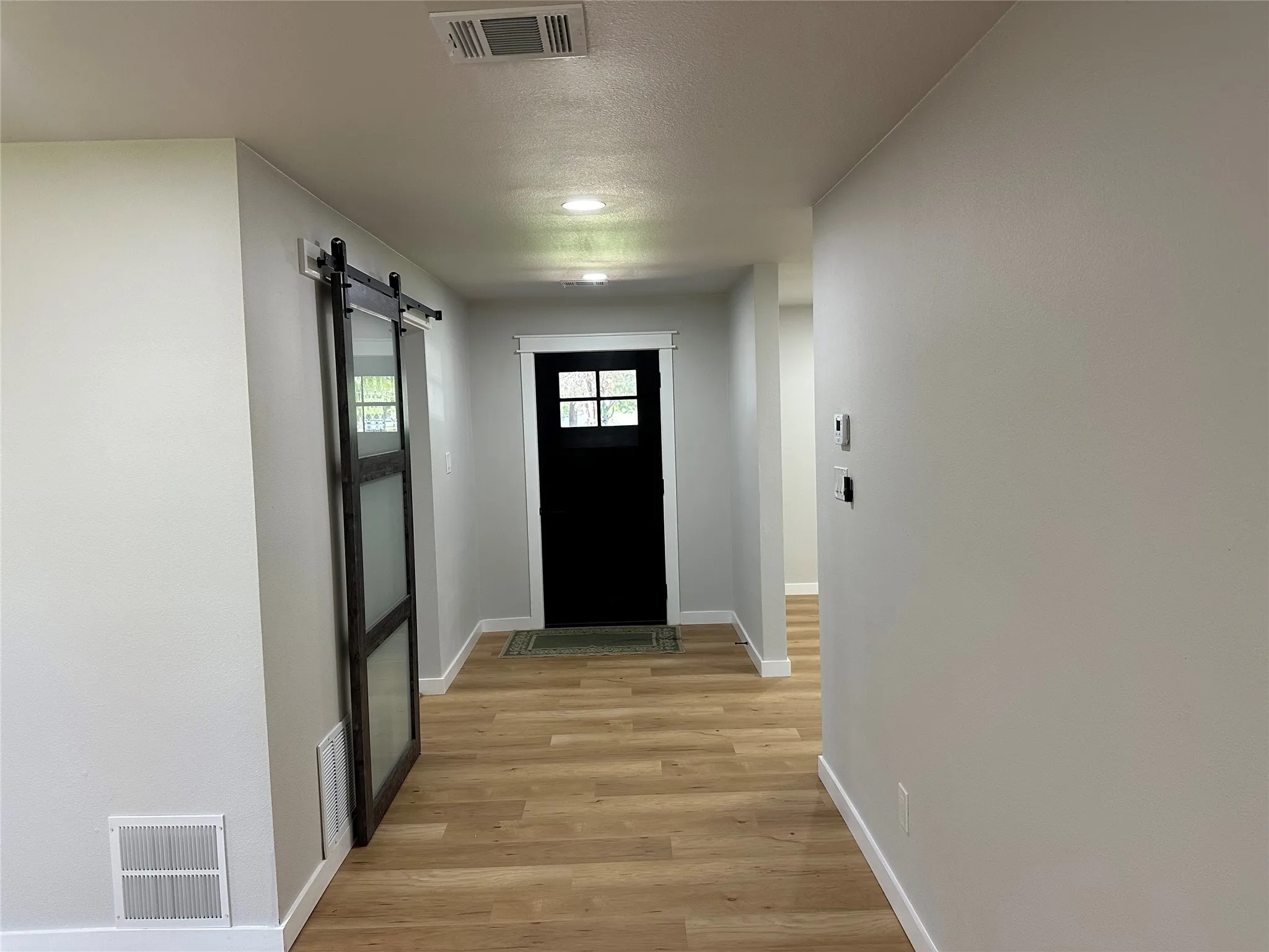 Doorway featuring a barn door and light hardwood / wood-style flooring