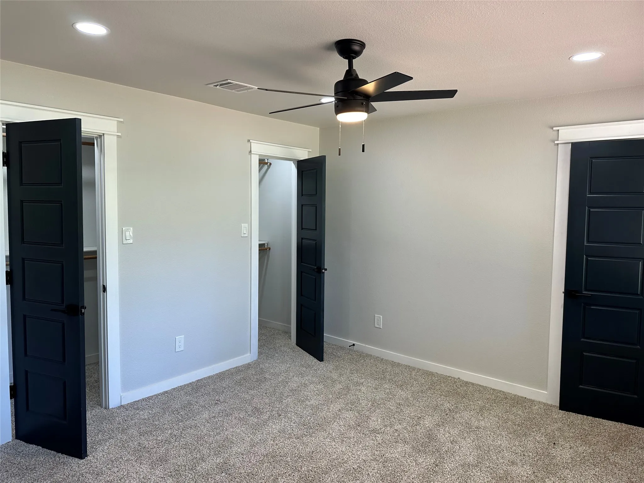Unfurnished bedroom with carpet and ceiling fan