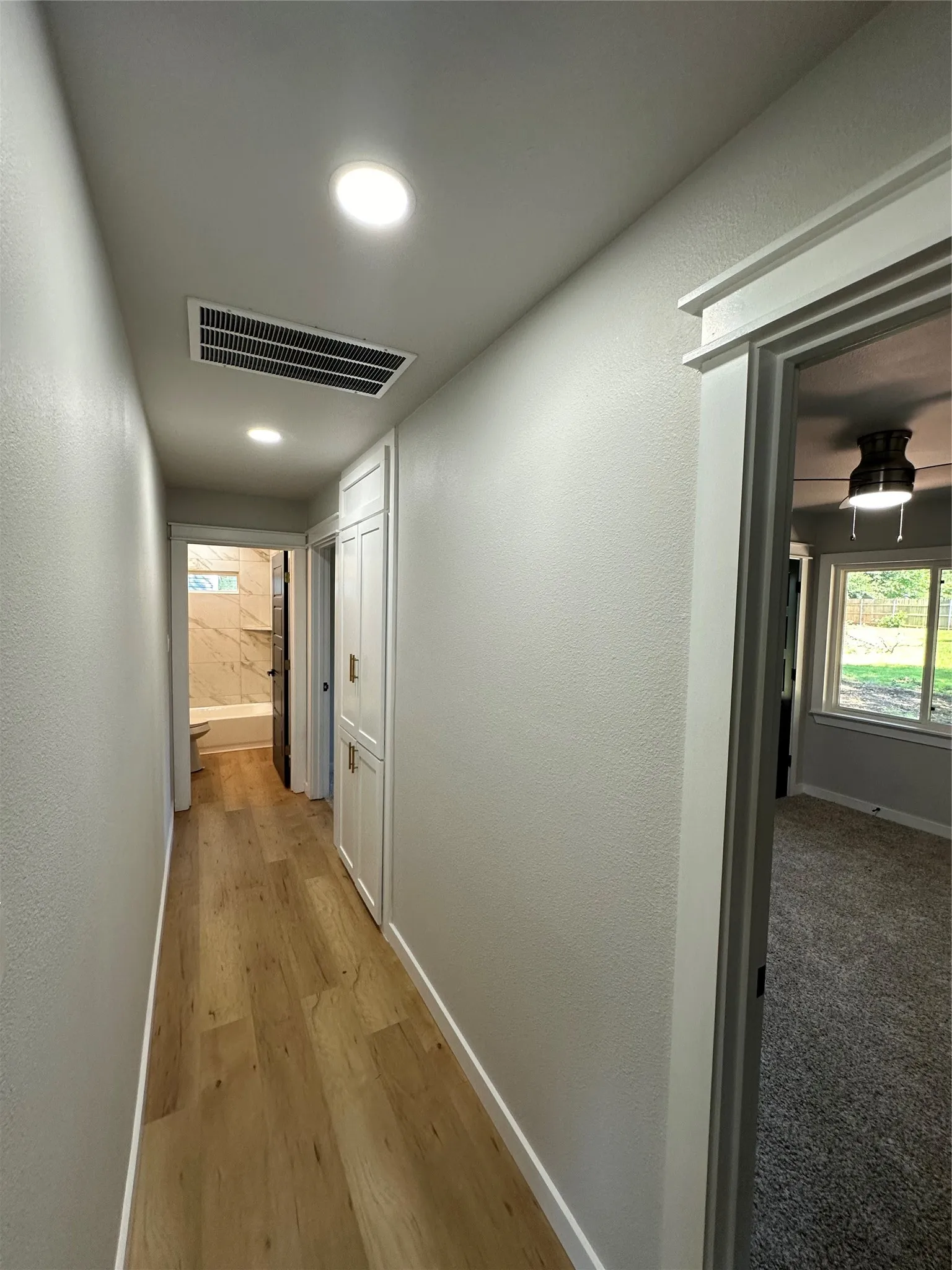 Hallway with carpet flooring