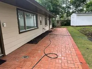 View of patio featuring a storage shed