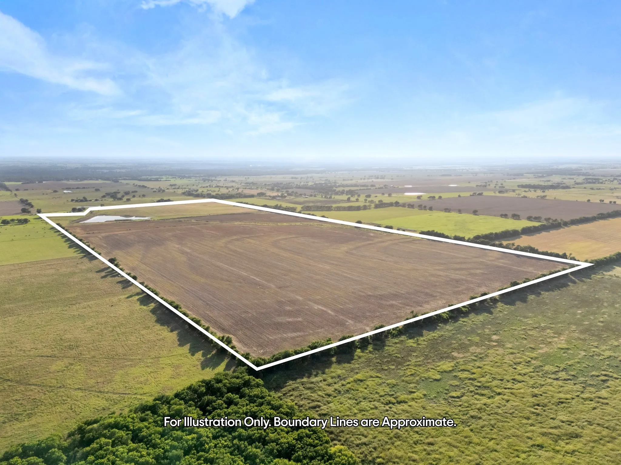Expansive undeveloped land featuring a cleared field and natural vegetation