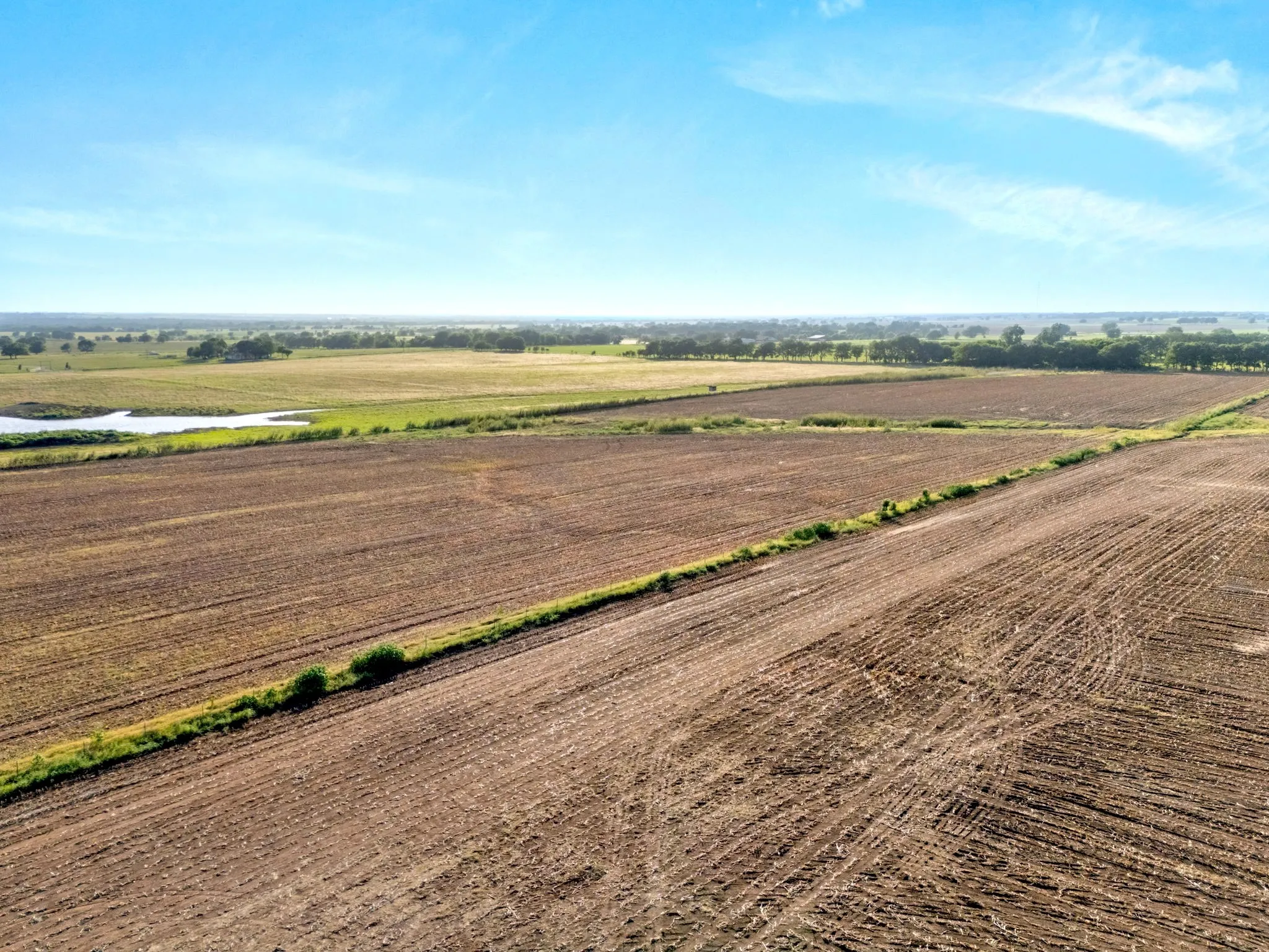 Expansive tilled agricultural land with distinct field divisions