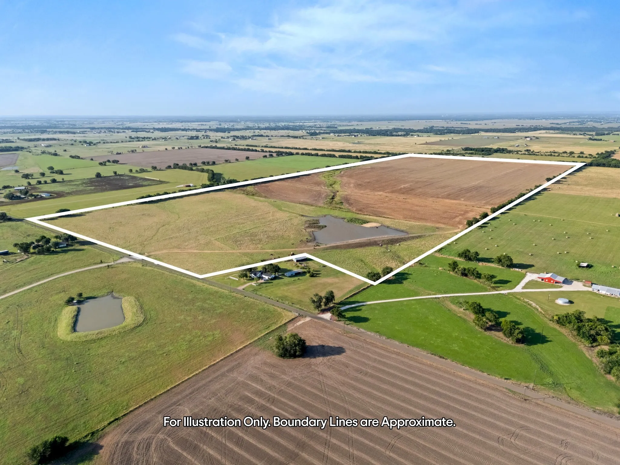 Expansive rural property featuring a large portion of tilled land, several sections of green pasture, and multiple ponds