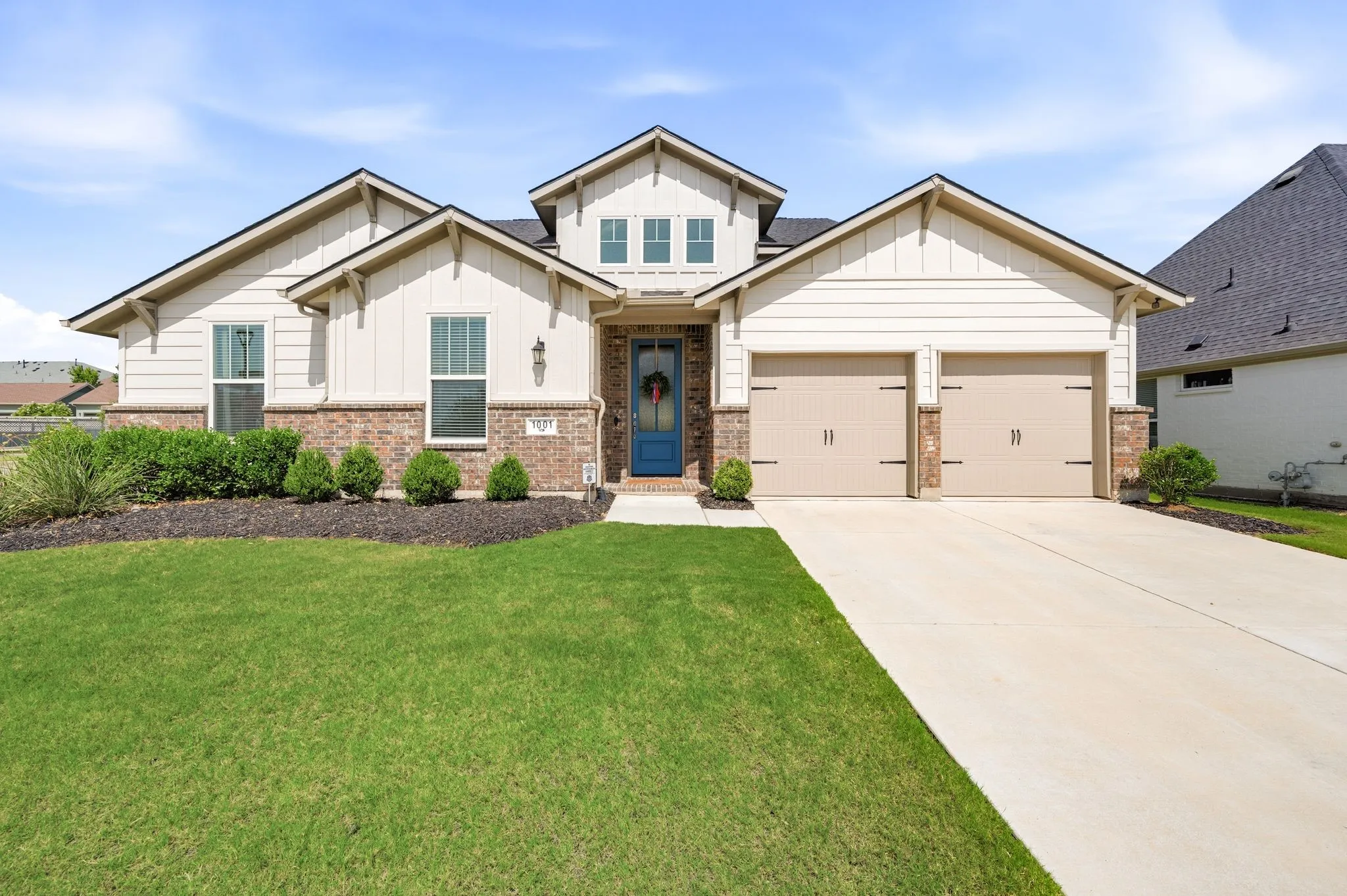 Just a beautiful contemporary farmhouse style home featuring brick and siding facade with a tandum three-car garage and amazing curb appeal.