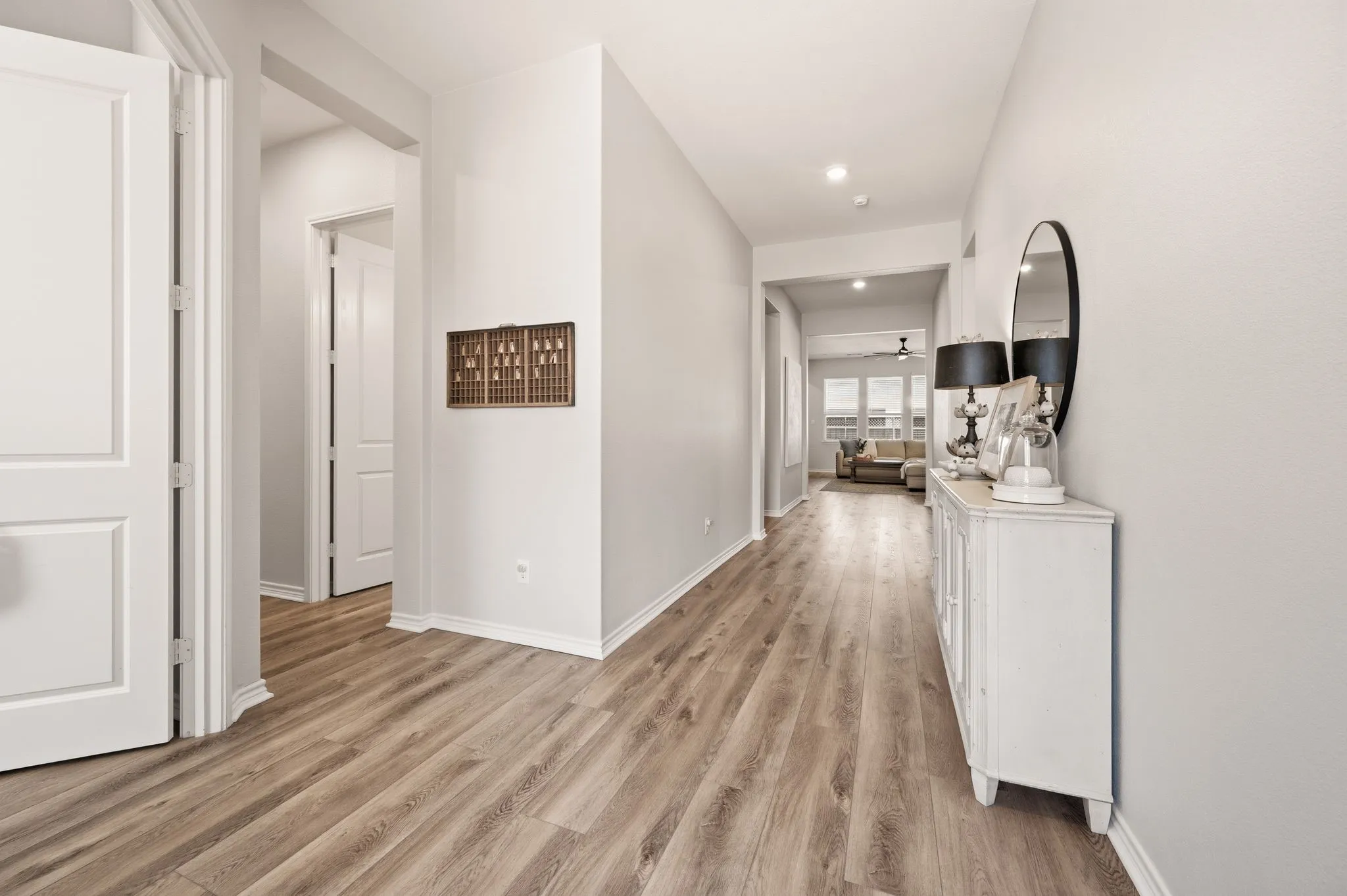 Entryway featuring High Quality LVP flooring, fresh painted walls, recessed lighting and you can see all the beautiful natural light throughout this home!