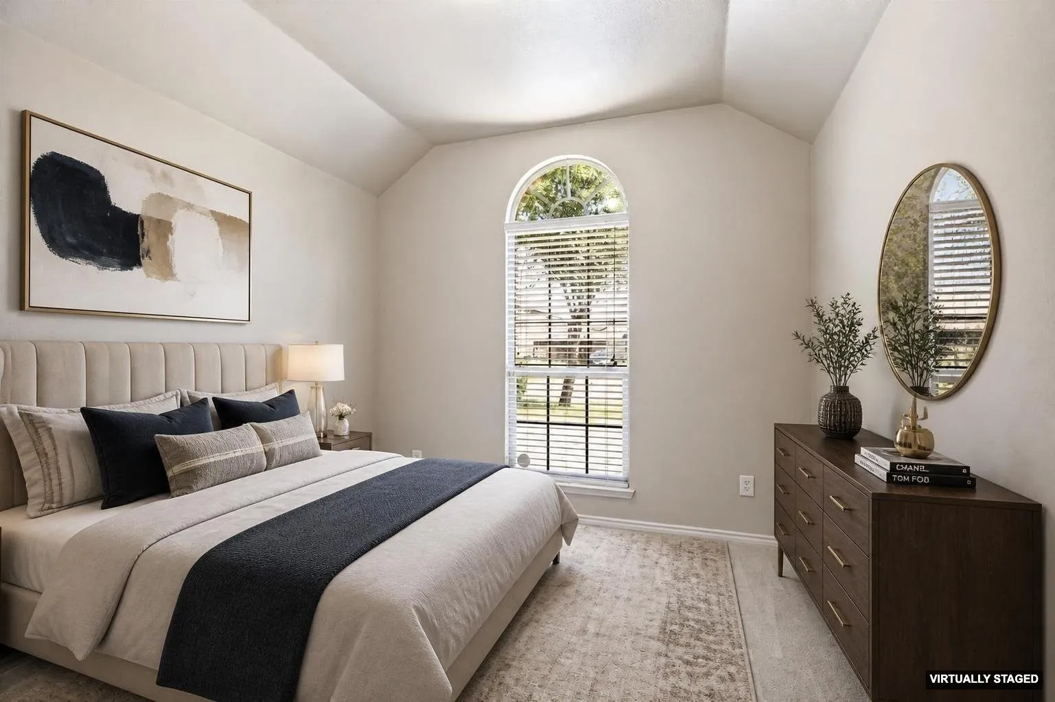 Staged,Vaulted ceiling bedroom featuring an arched window with blinds, light wood-finish flooring, and light-toned wall paint