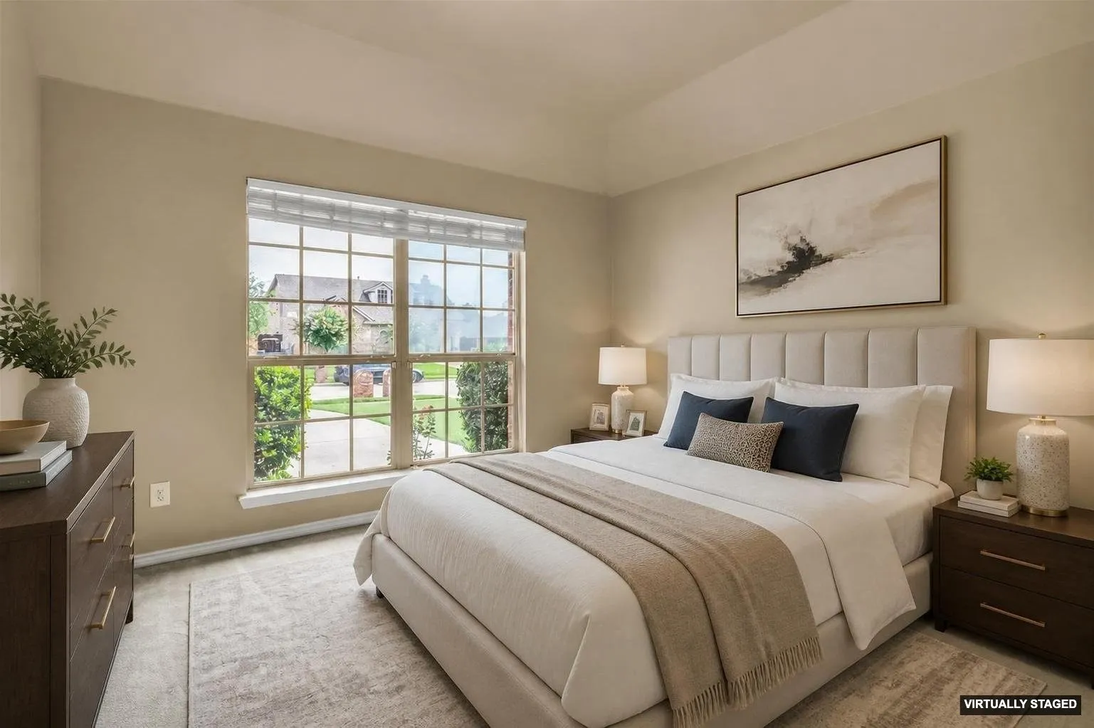 Staged, Spacious bedroom featuring light neutral wall tones, a large window with white blinds, and plush carpeting