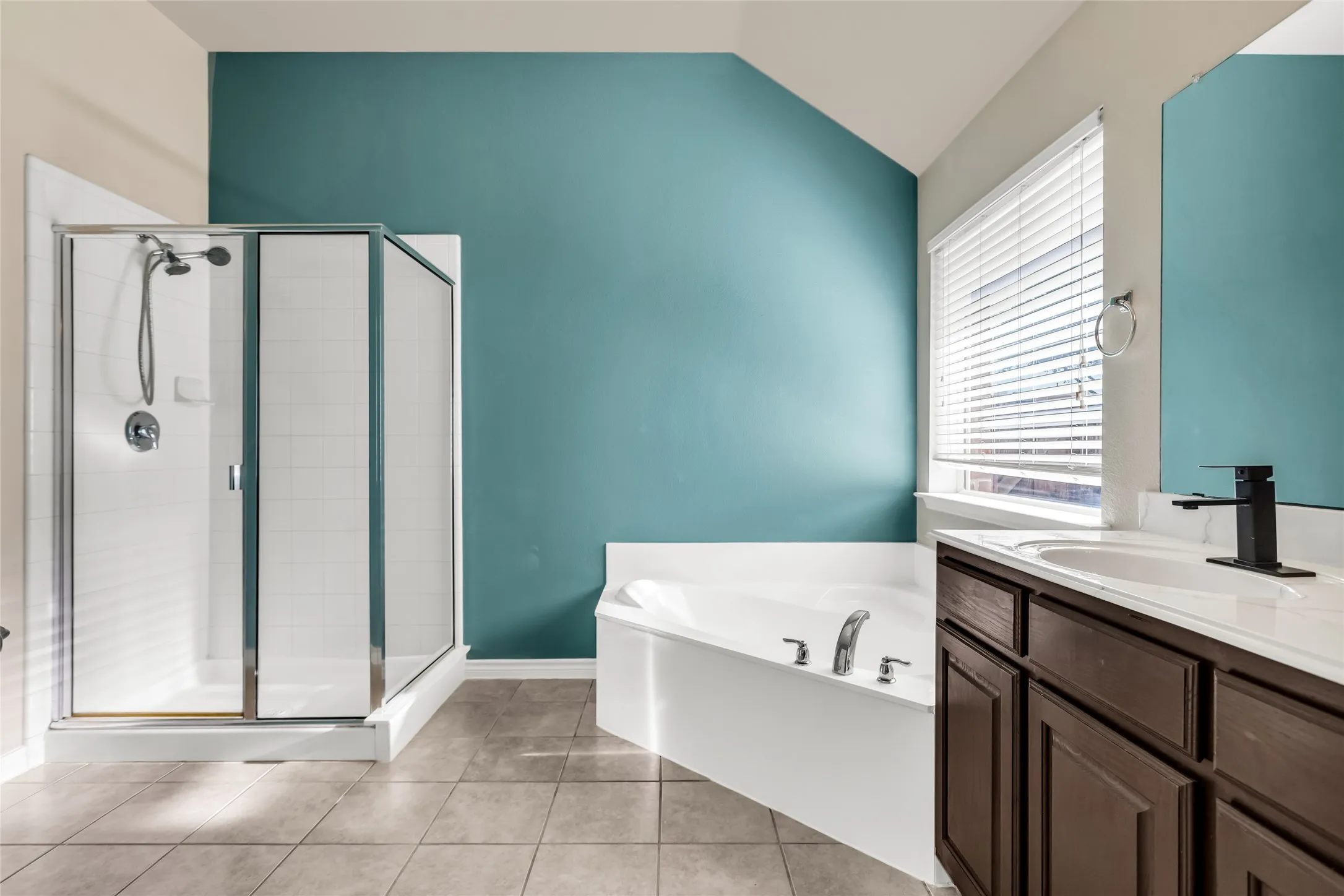 primary bath with soaking tub and separate shower with double vanities.