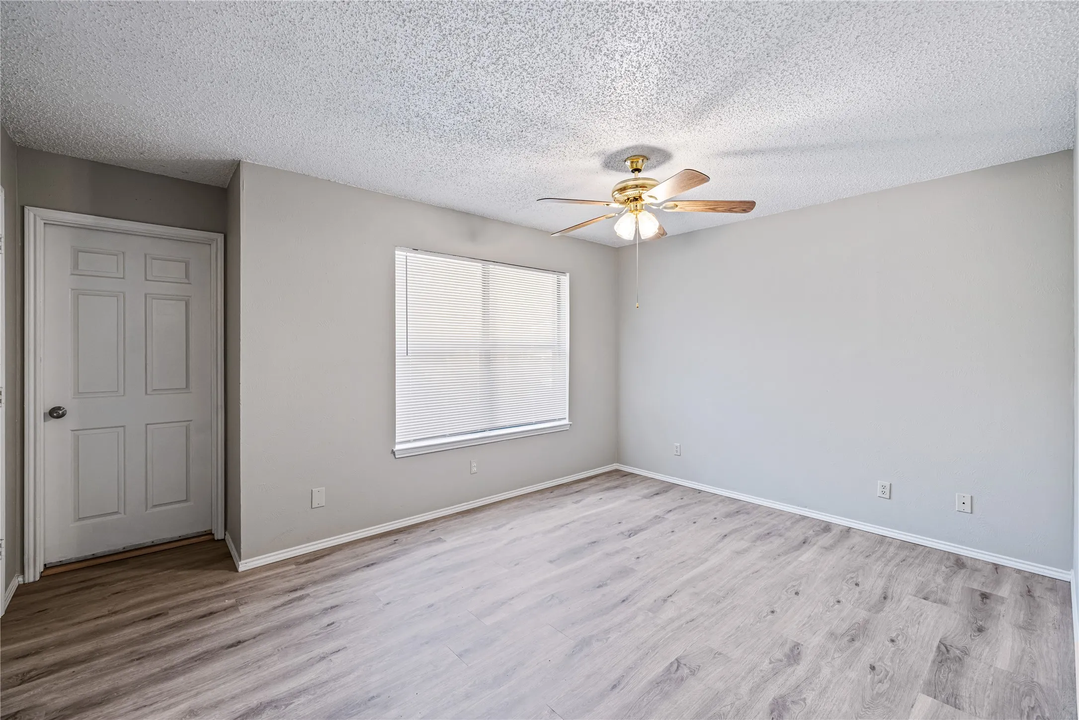 Unfurnished room with  baseboards, light wood-style floors, and ceiling fan