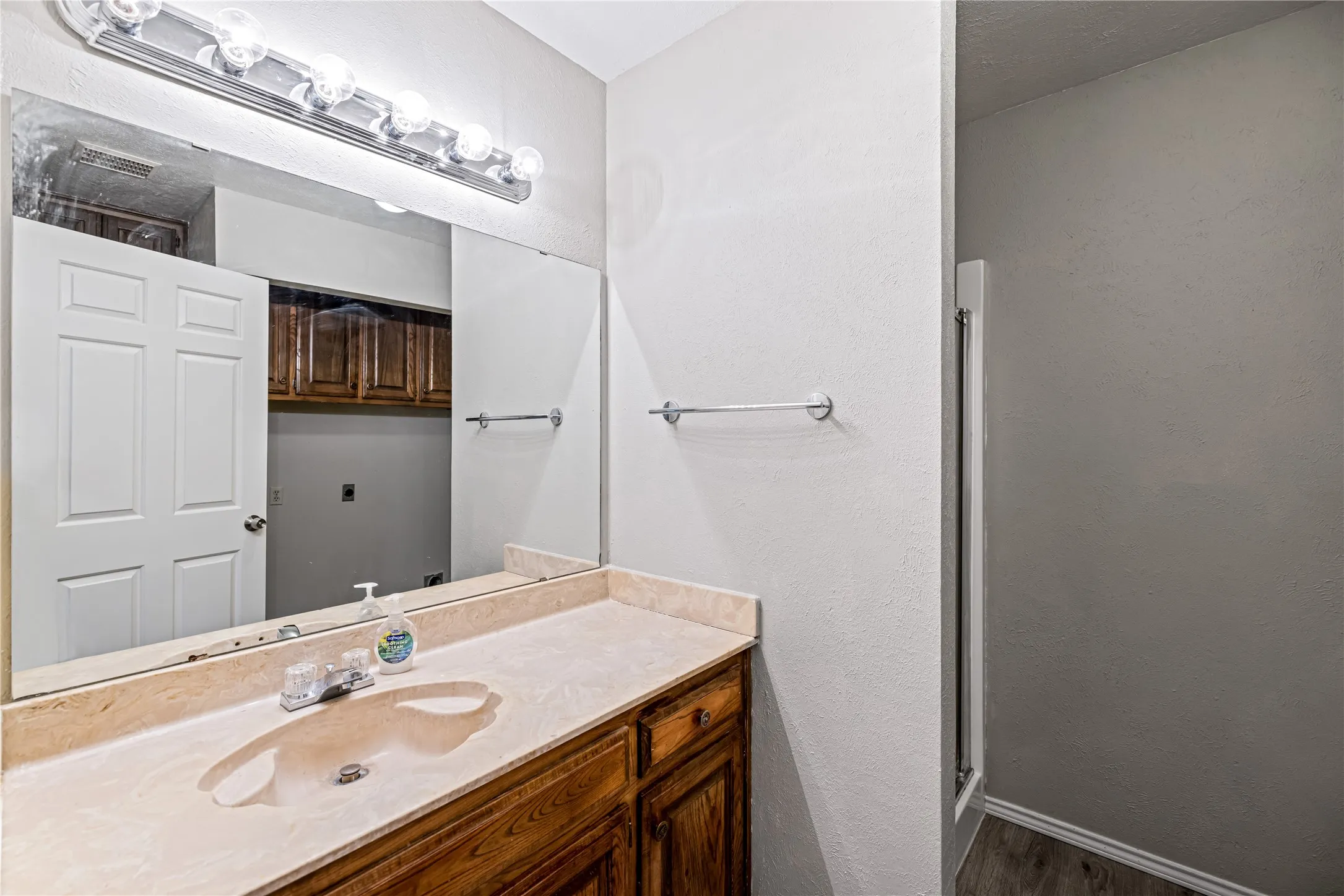 Full bathroom with an enclosed shower, baseboards, and vanity