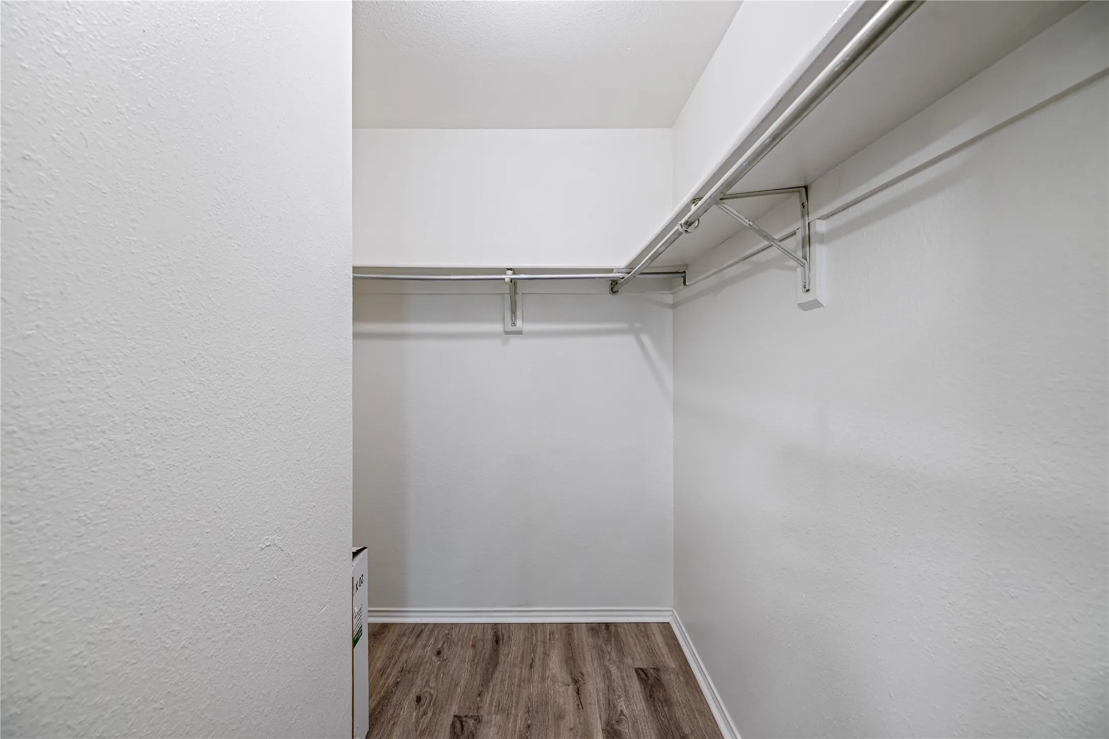 Spacious closet with wood finished floors