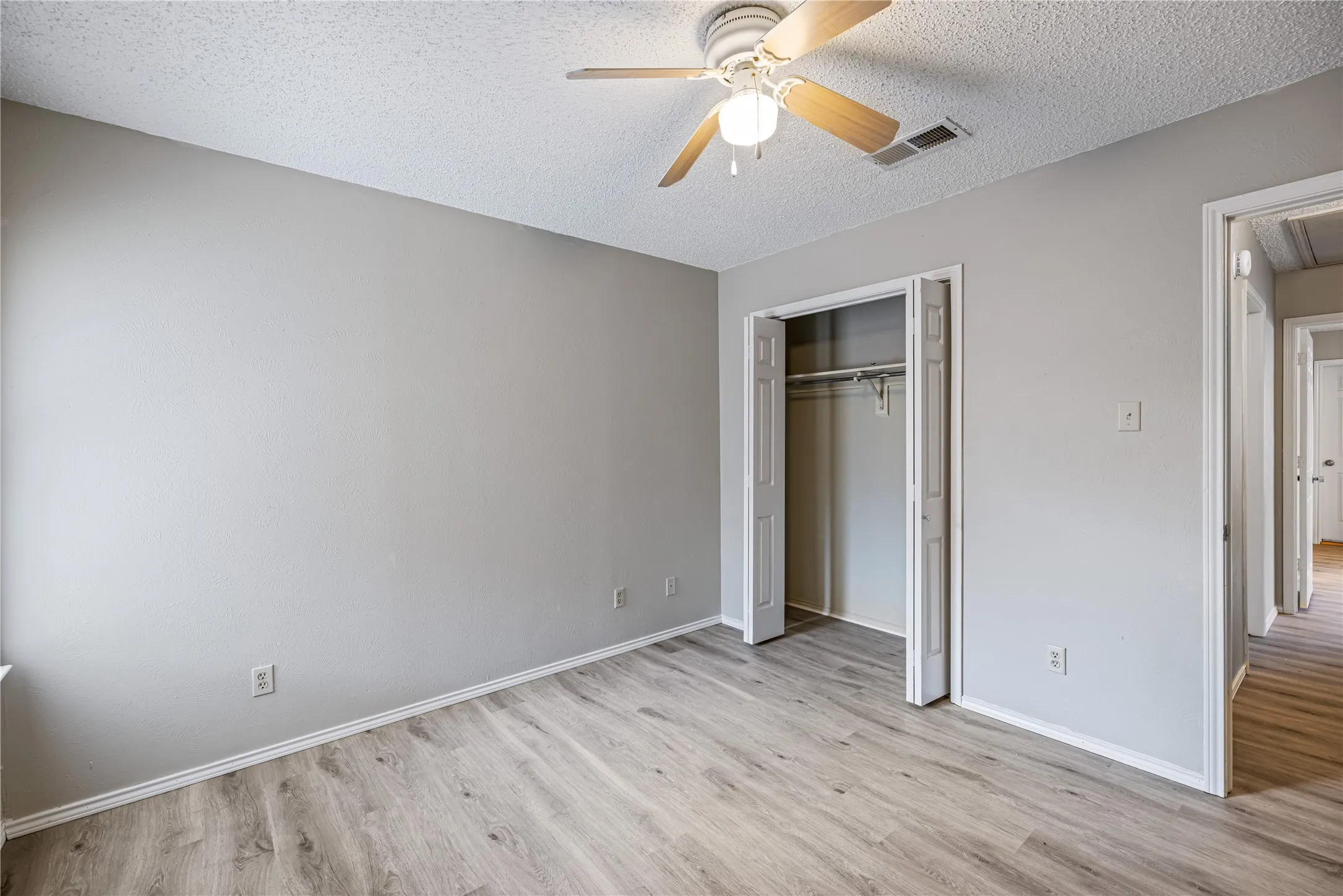 Unfurnished bedroom with baseboards, and wood finished floors