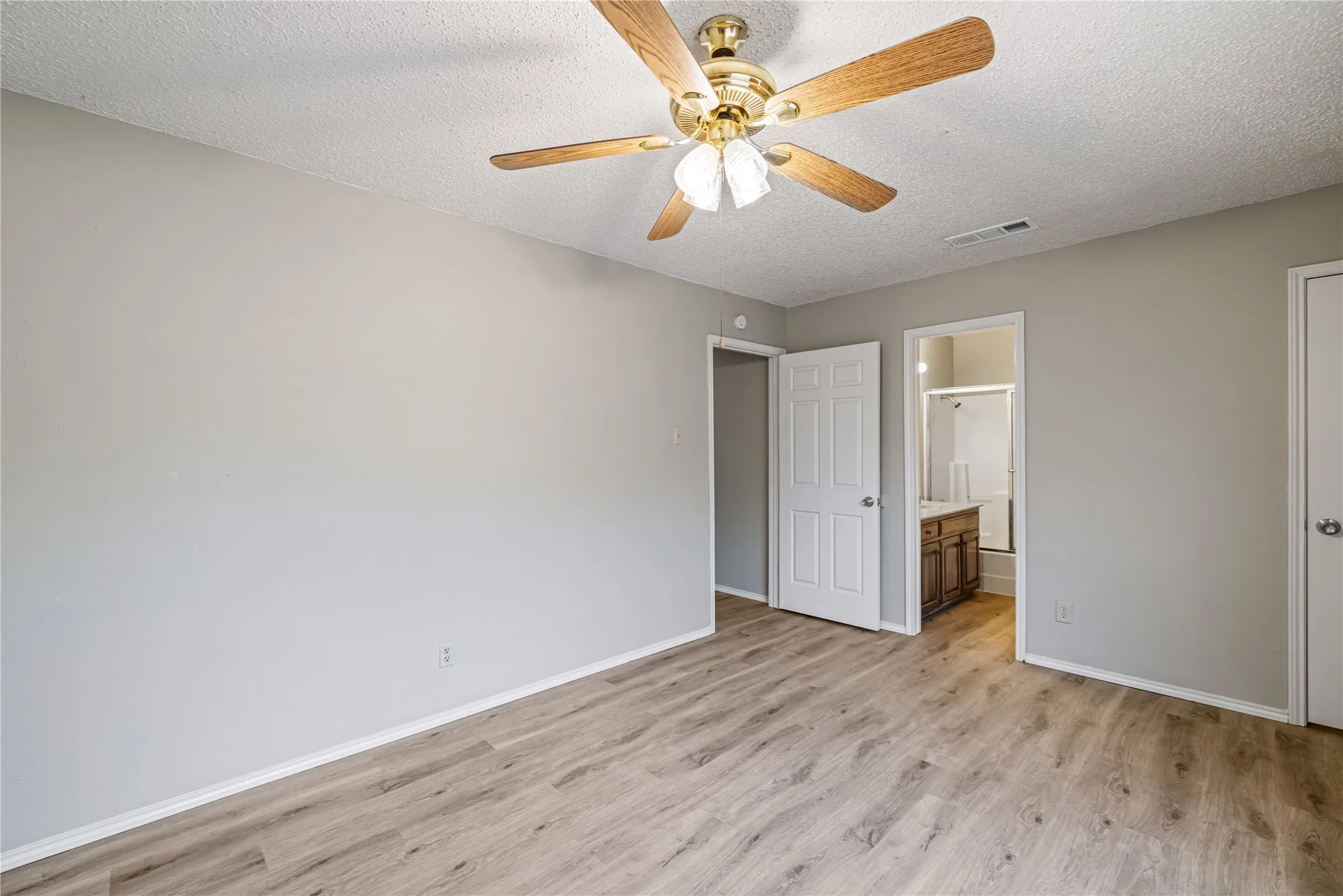 Unfurnished bedroom featuring baseboards, light wood-style floors