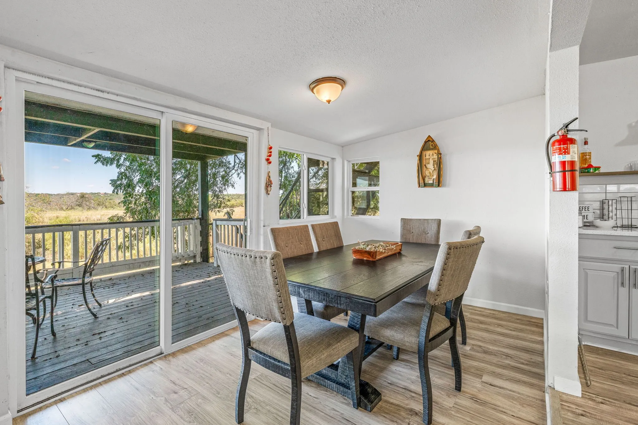 Dining area featuring light wood-style floors and a textured ceiling