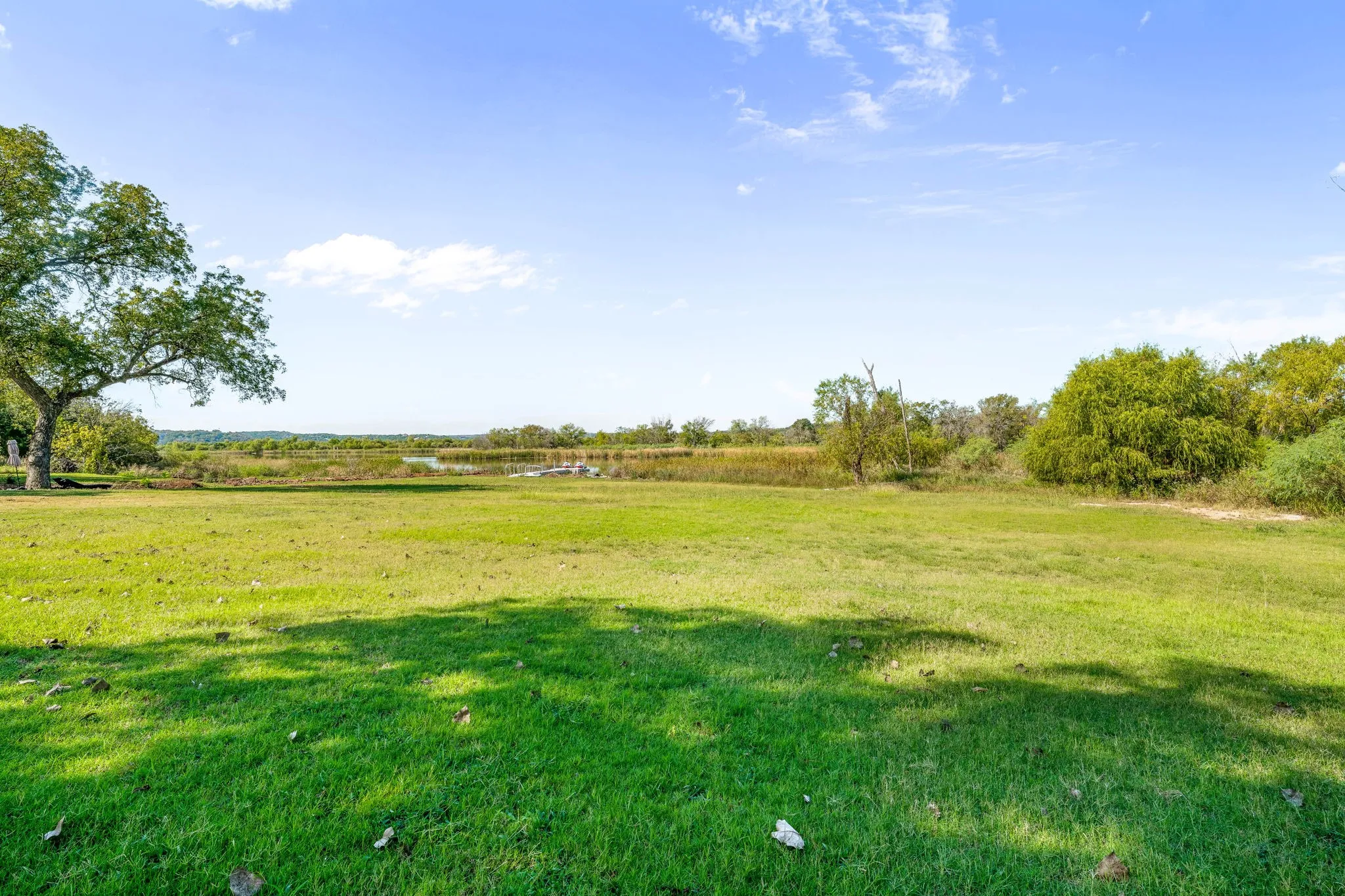 View of grassy yard with a view of rural / pastoral area and a water view