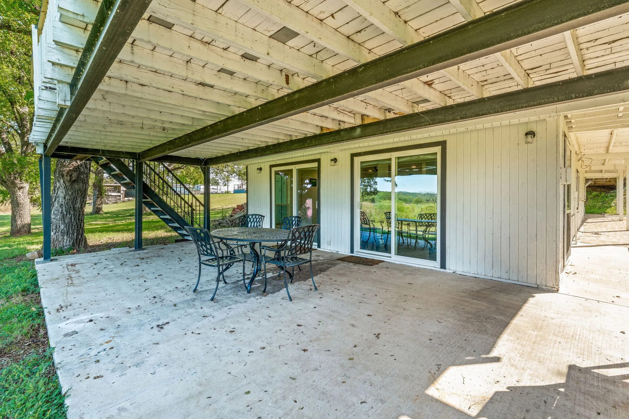 View of patio with stairway and outdoor dining area