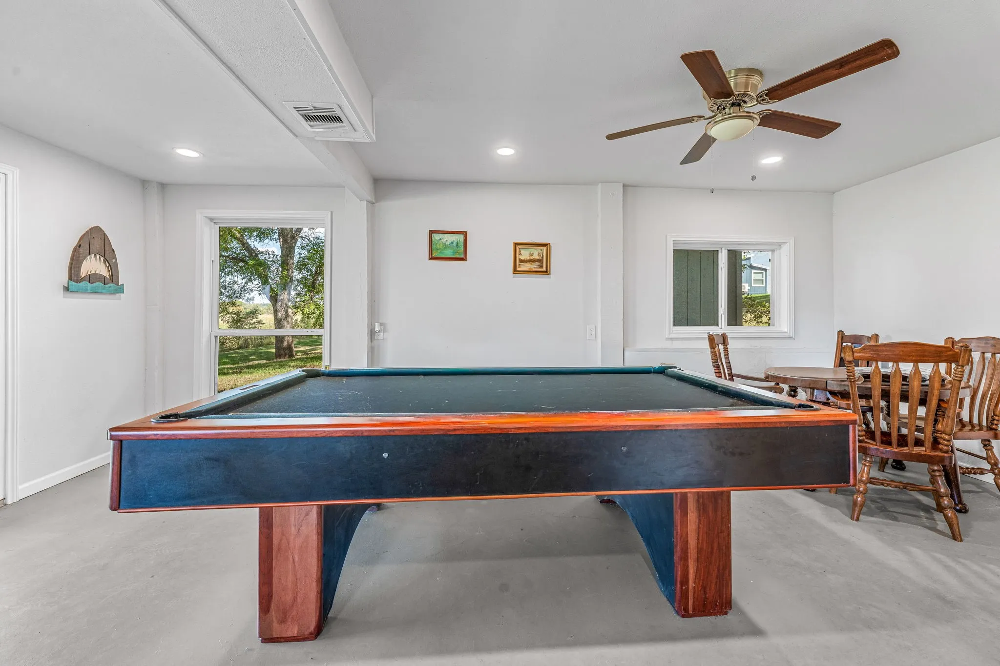 Recreation room with billiards table, finished concrete floors, ceiling fan, and recessed lighting