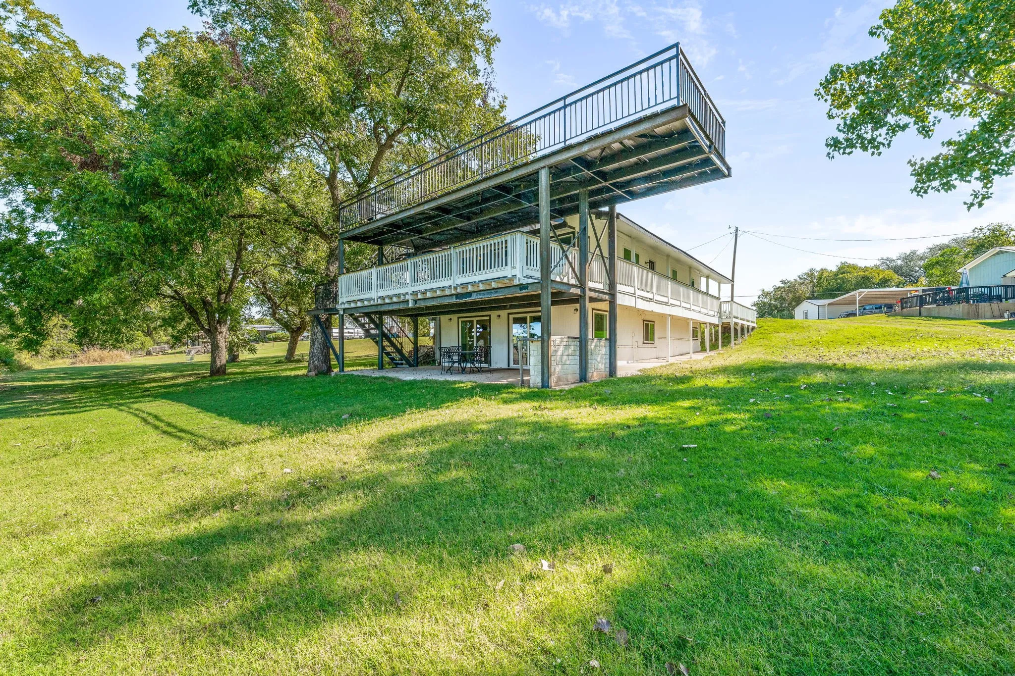 Back of house featuring a yard, a patio, stairway, and a deck