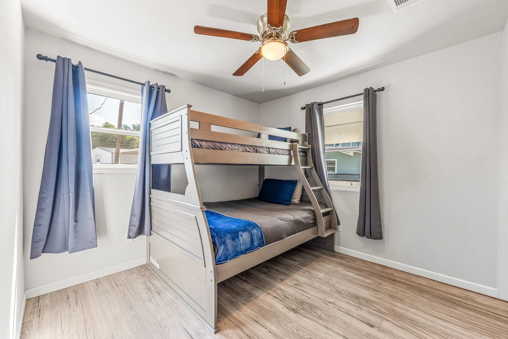 Bedroom featuring light wood-type flooring and a ceiling fan