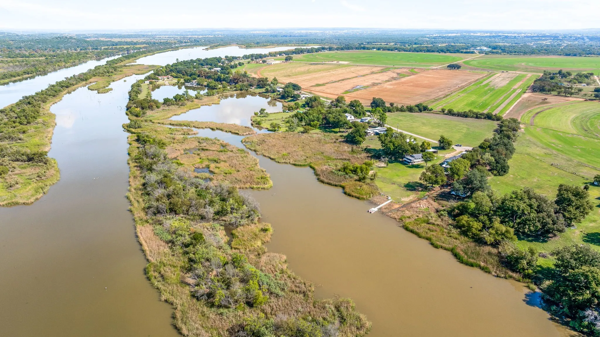 Aerial view of property's location with a nearby body of water and rural landscape