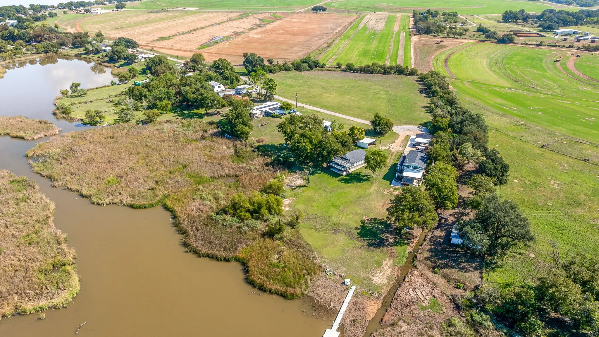 Aerial overview of property's location with rural landscape and a nearby body of water