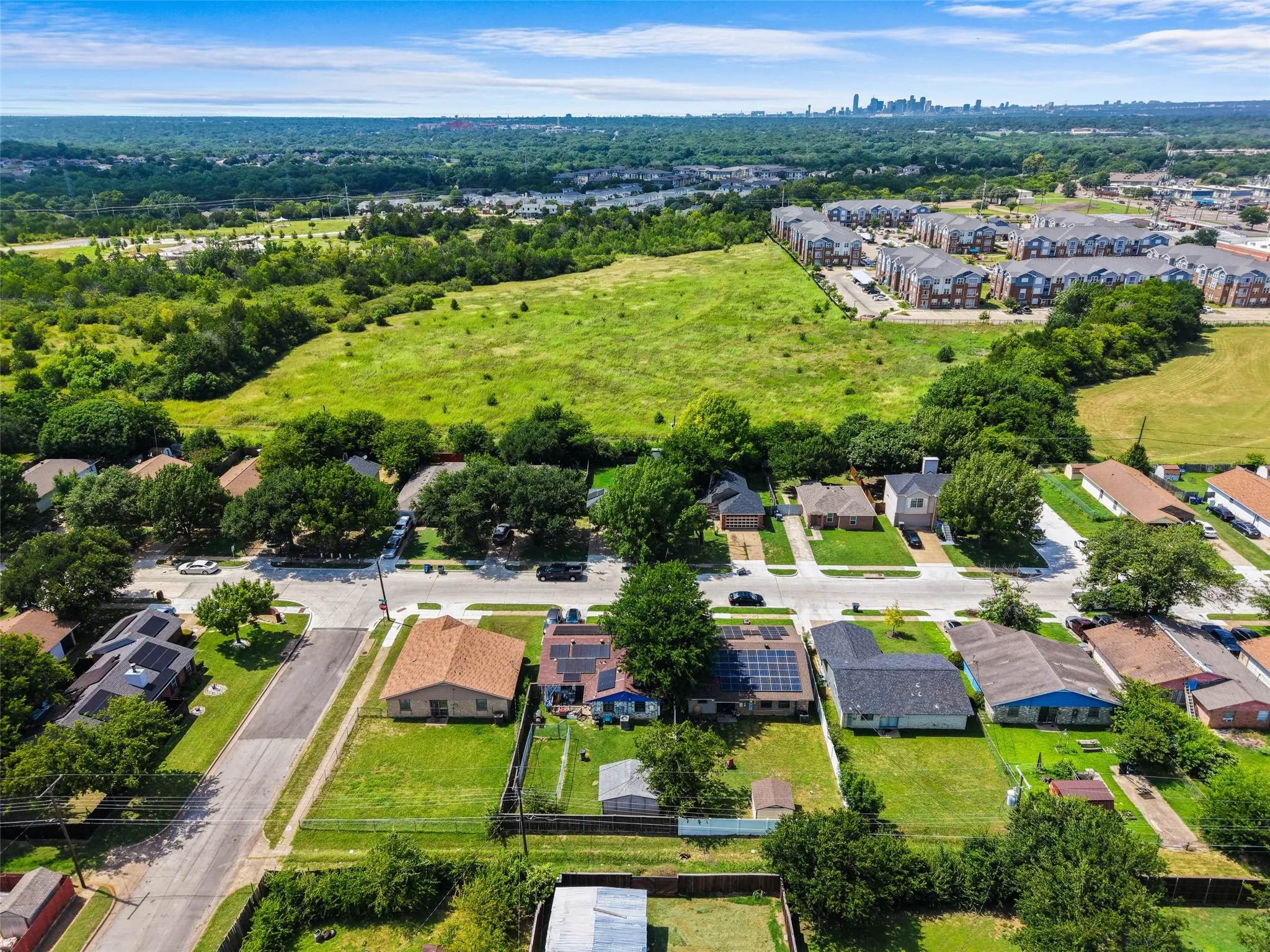 Aerial perspective showcasing residential properties with a verdant landscape