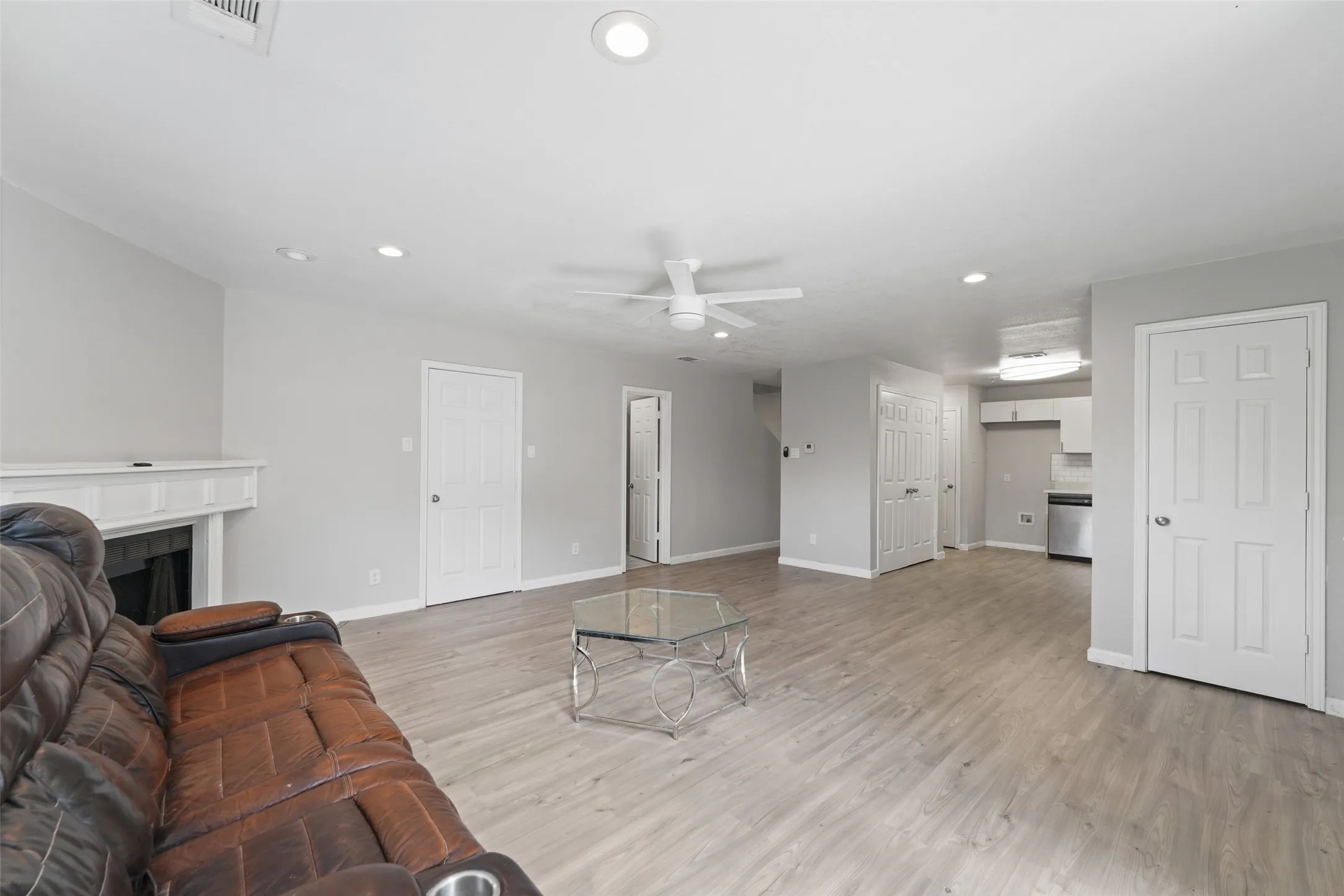 Open-concept living area featuring wood-finish flooring and recessed lighting