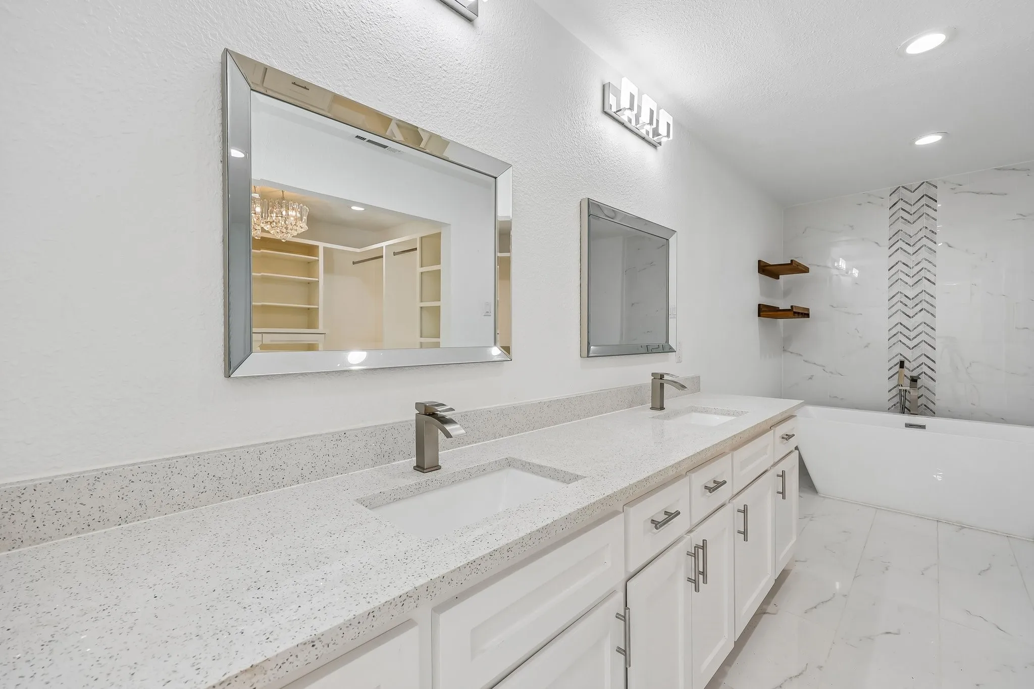 Double vanity featuring quartz countertops, undermount sinks, and brushed nickel fixtures
