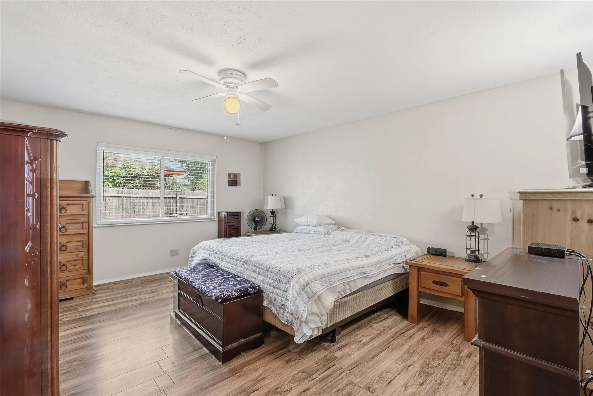  Private, split-floorplan primary suite featuring laminate flooring and clear backyard views.