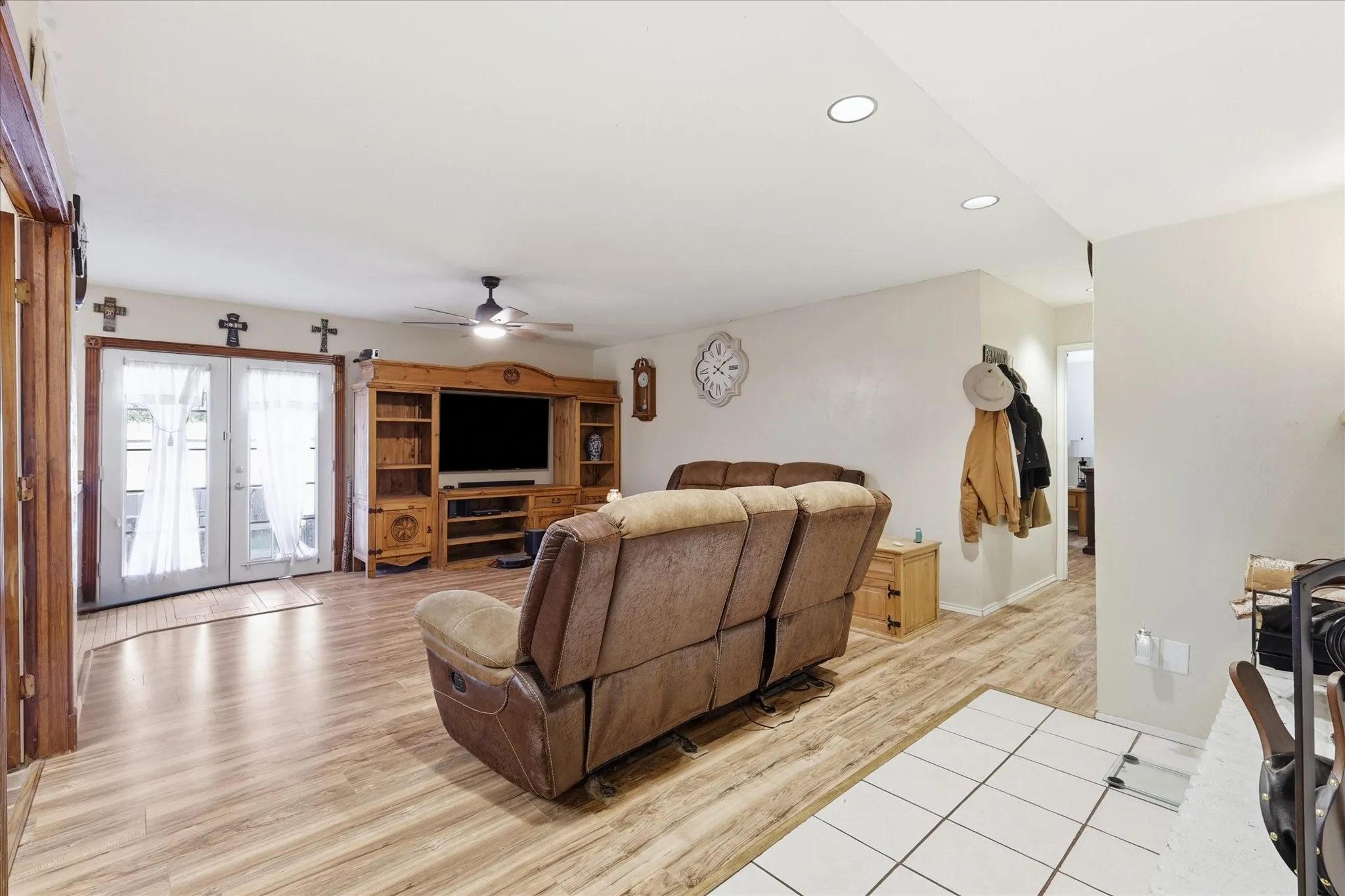 Living area with double doors to covered patio, no carpet, and 3-year-old high-efficiency windows.
