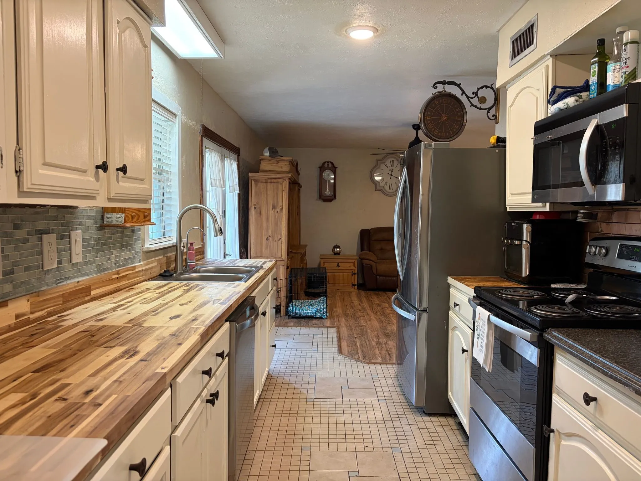 Updated kitchen featuring a new sink, faucet, and an under-sink reverse osmosis system.