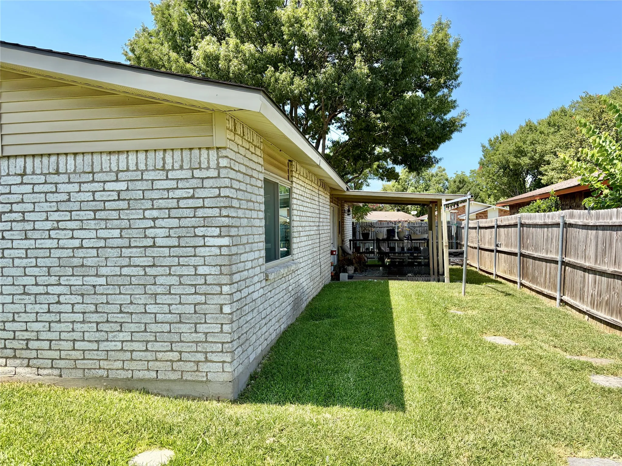 Patio: showing a covered rear patio and a sturdy wood fence with galvanized steel poles.