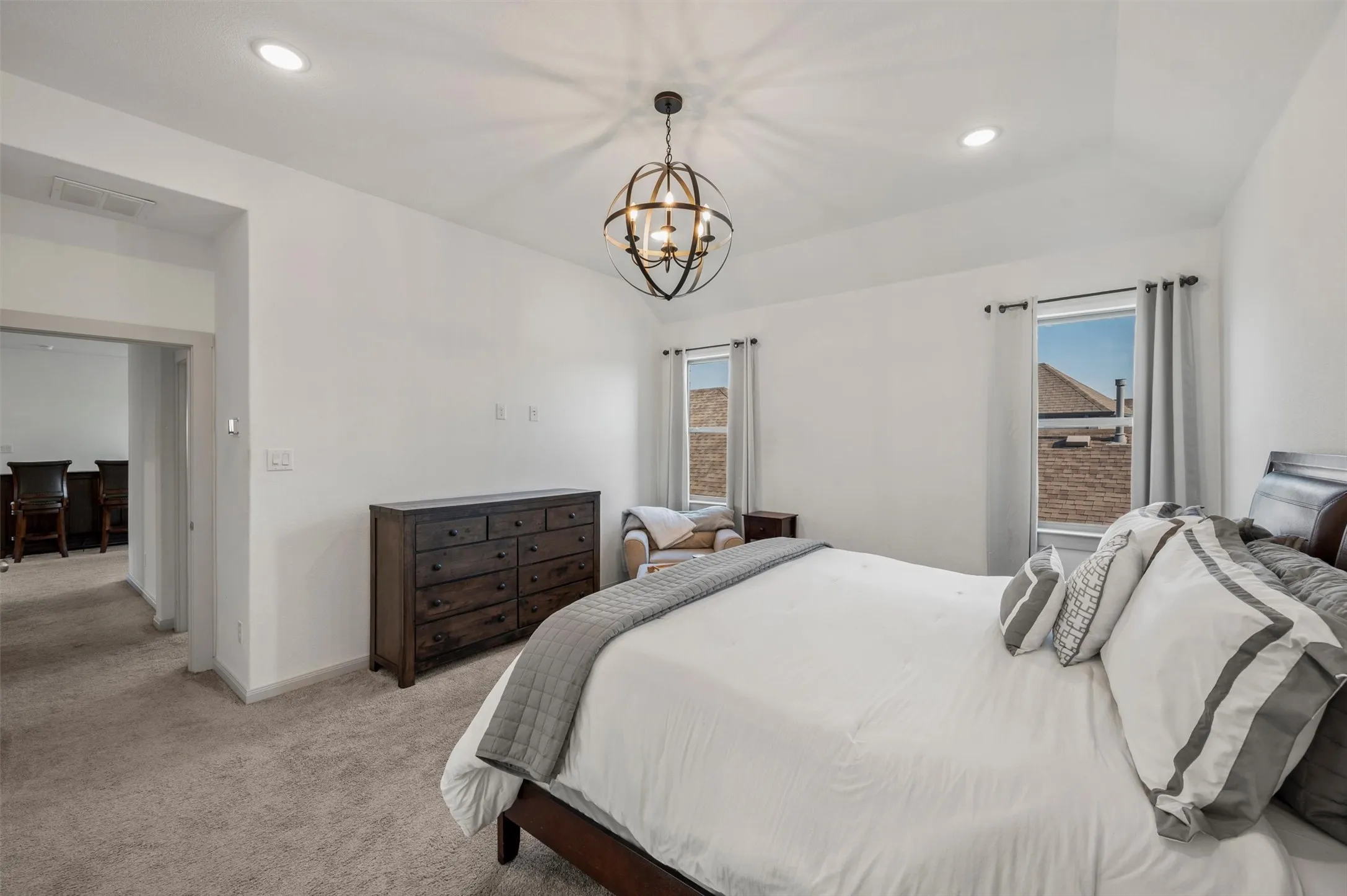 Recessed ceiling lighting, vaulted ceiling, and an ornate spherical chandelier