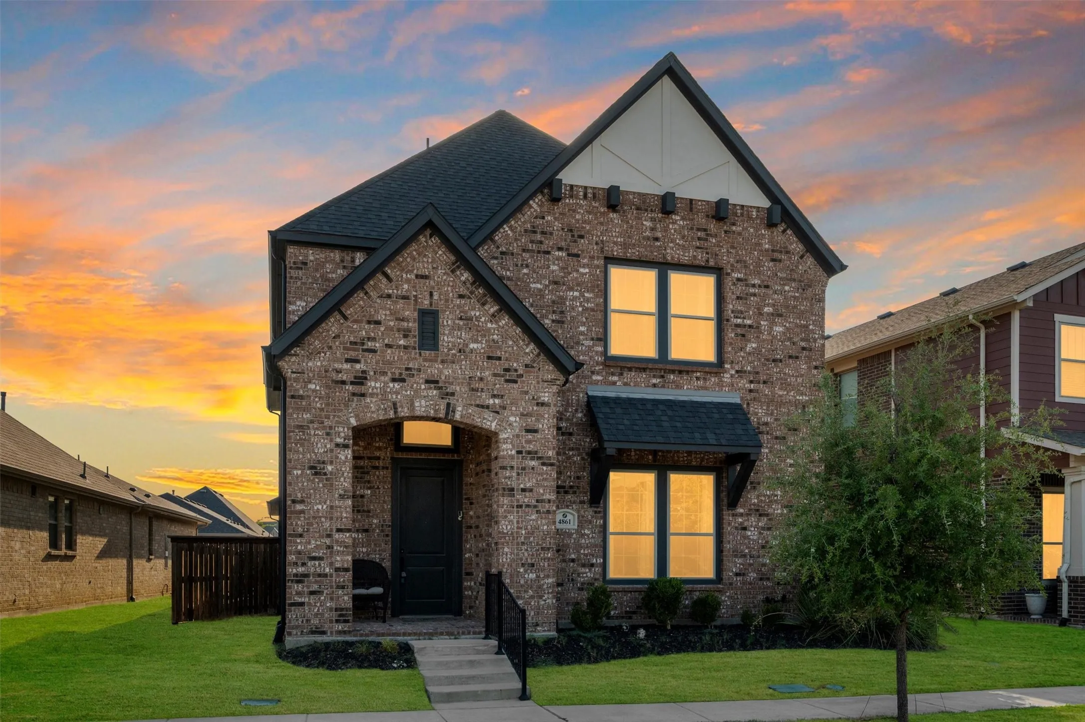 Brick exterior with dark trim and arched entry