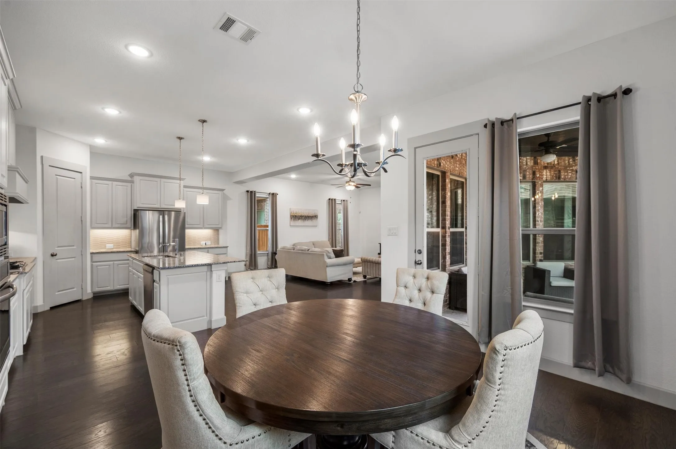 Open-concept living space with dark wood-finish flooring