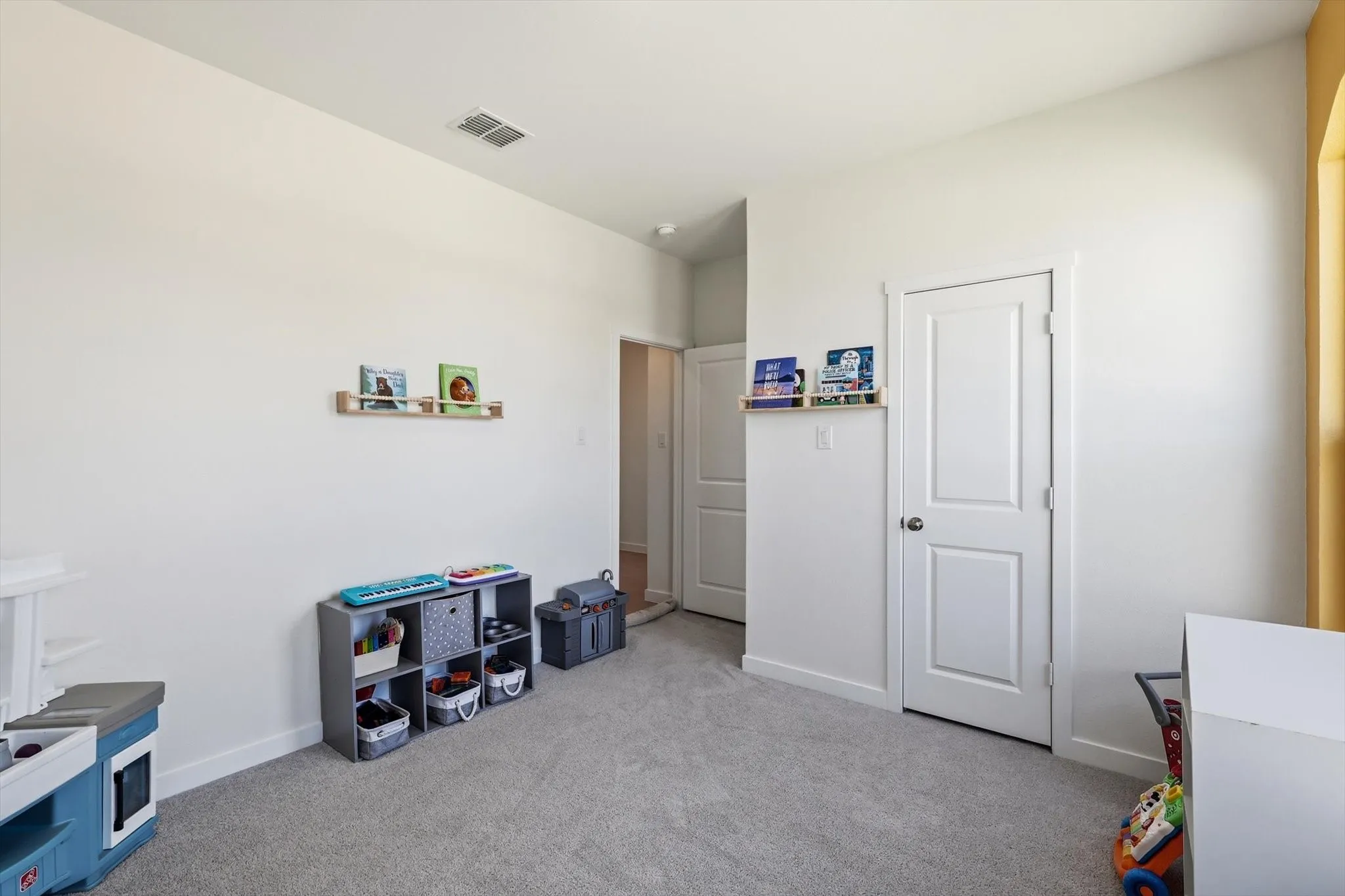 Room featuring neutral wall finishes and light gray carpeting