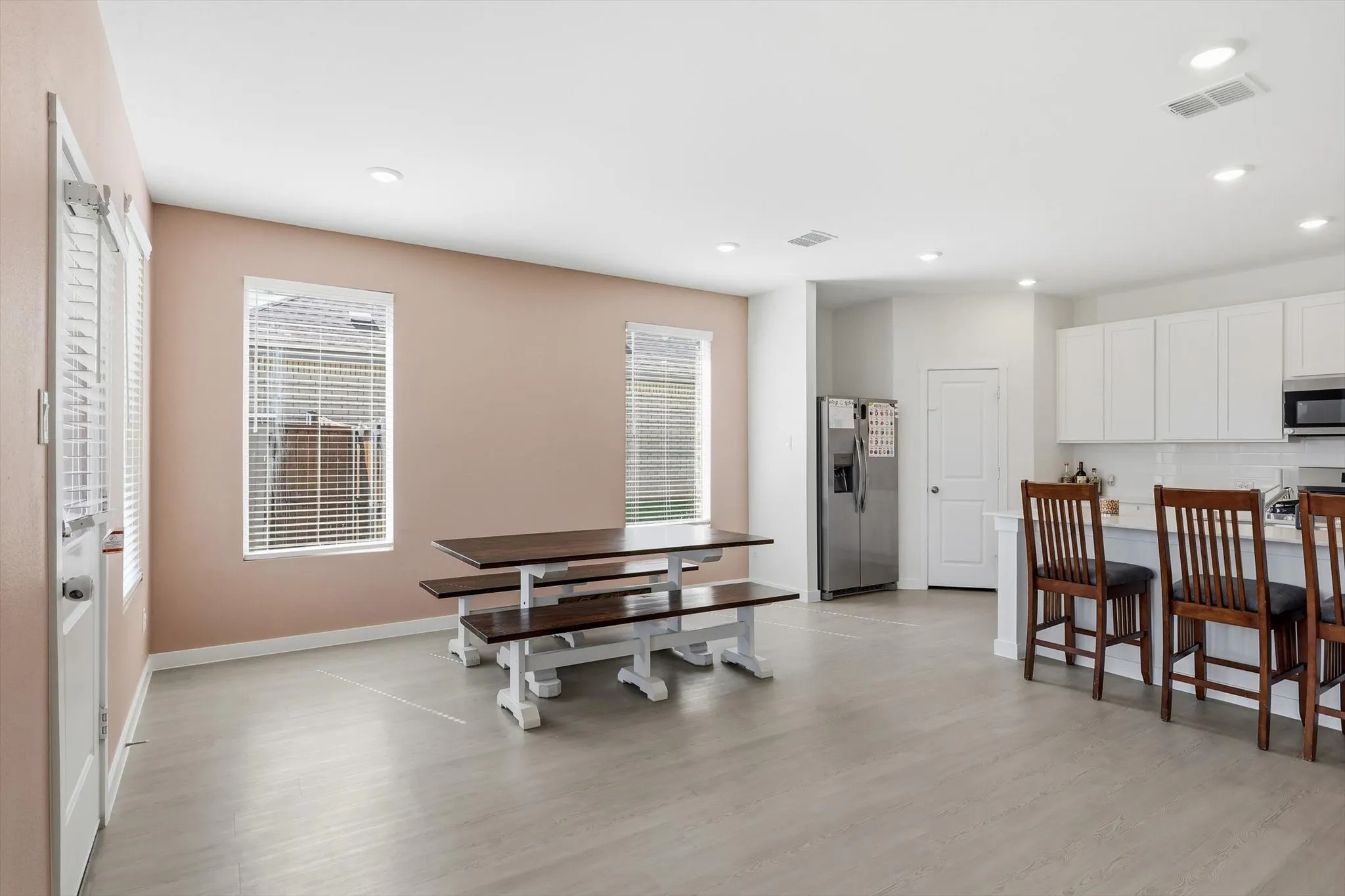 Open-concept room featuring light wood-finish flooring and recessed lighting