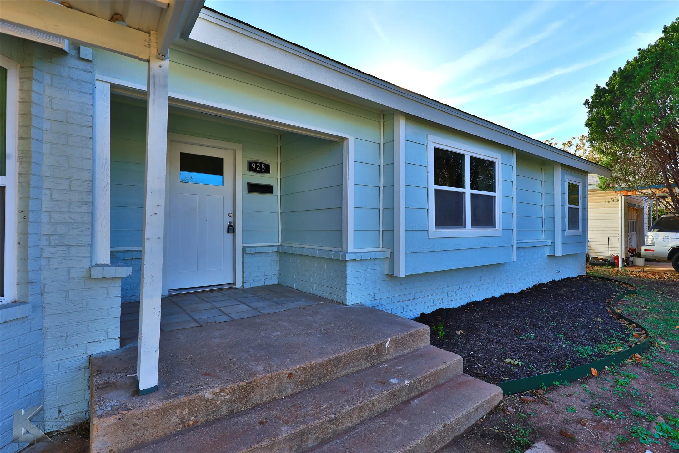 Light blue exterior featuring painted brick and horizontal siding