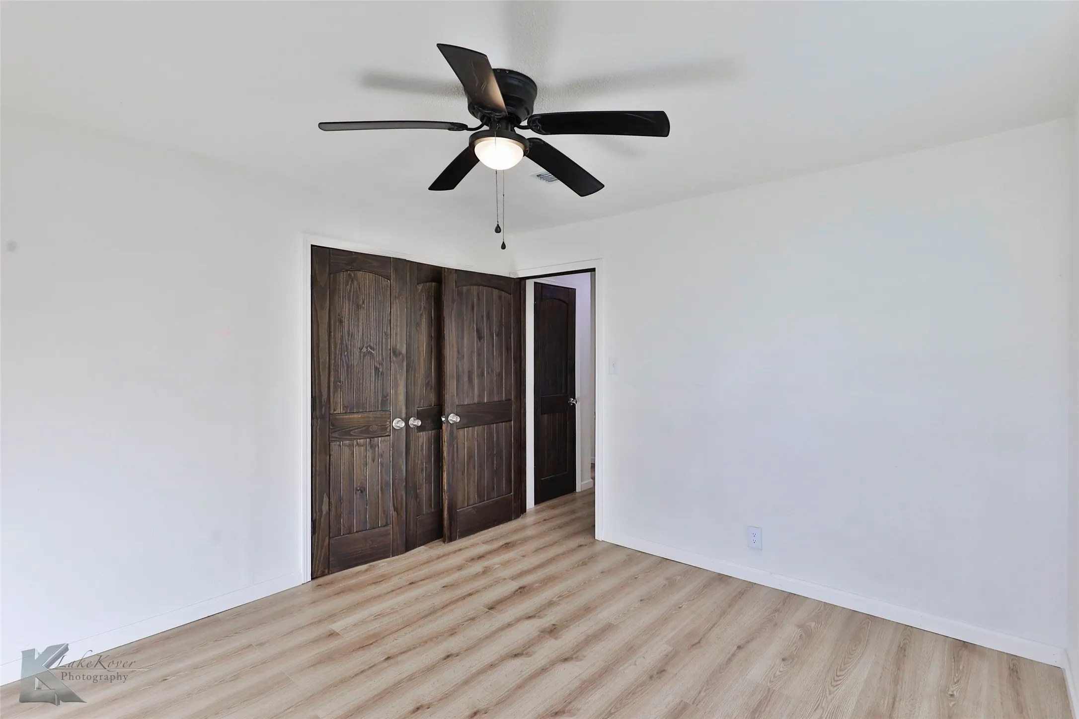 Room featuring light wood-finish flooring and white walls