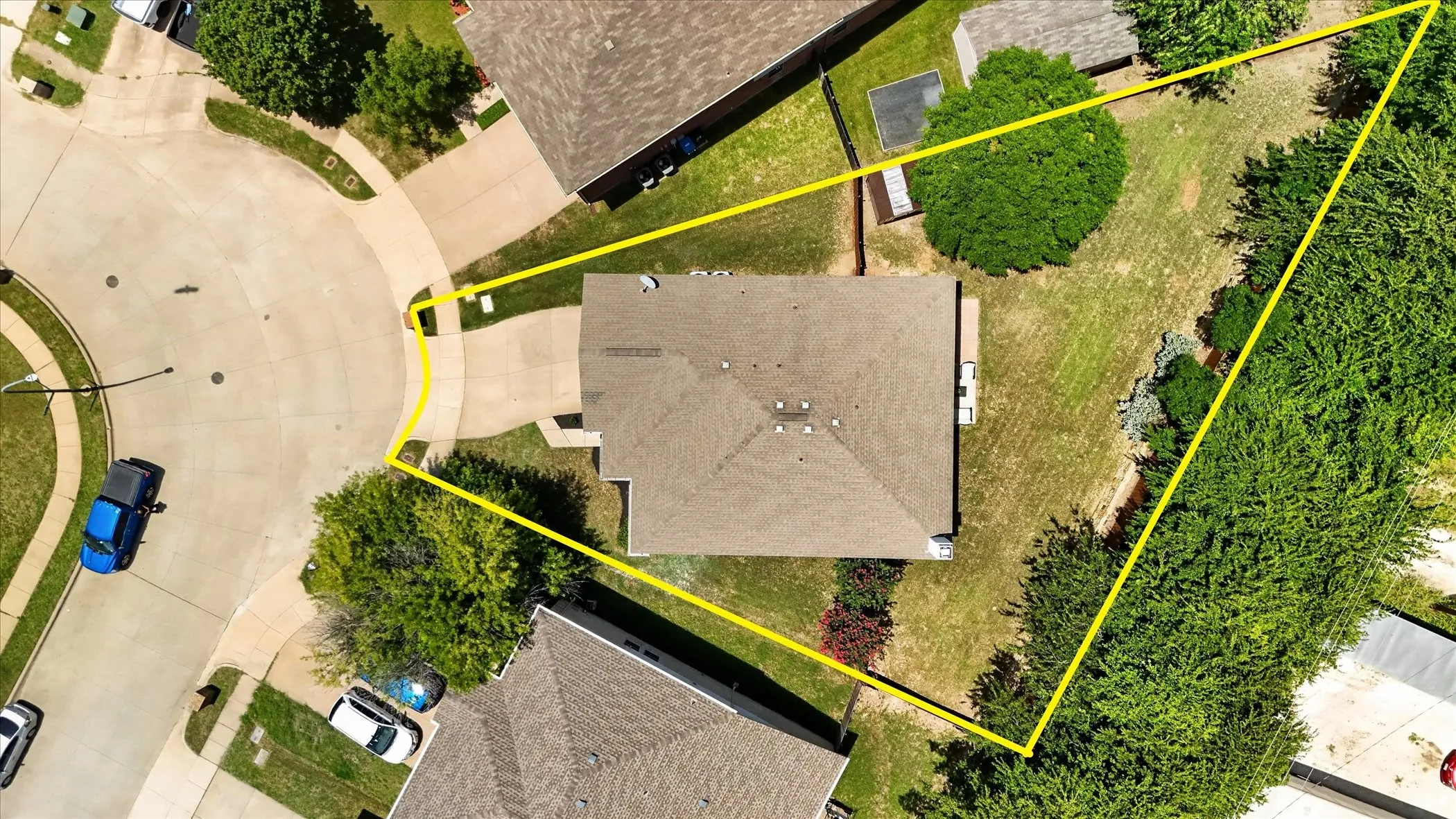 Expansive property with a large backyard featuring mature trees and a manicured lawn