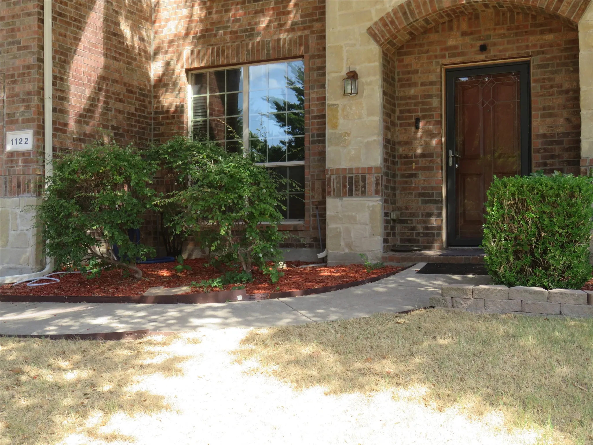 Brick and stone facade with an arched entryway