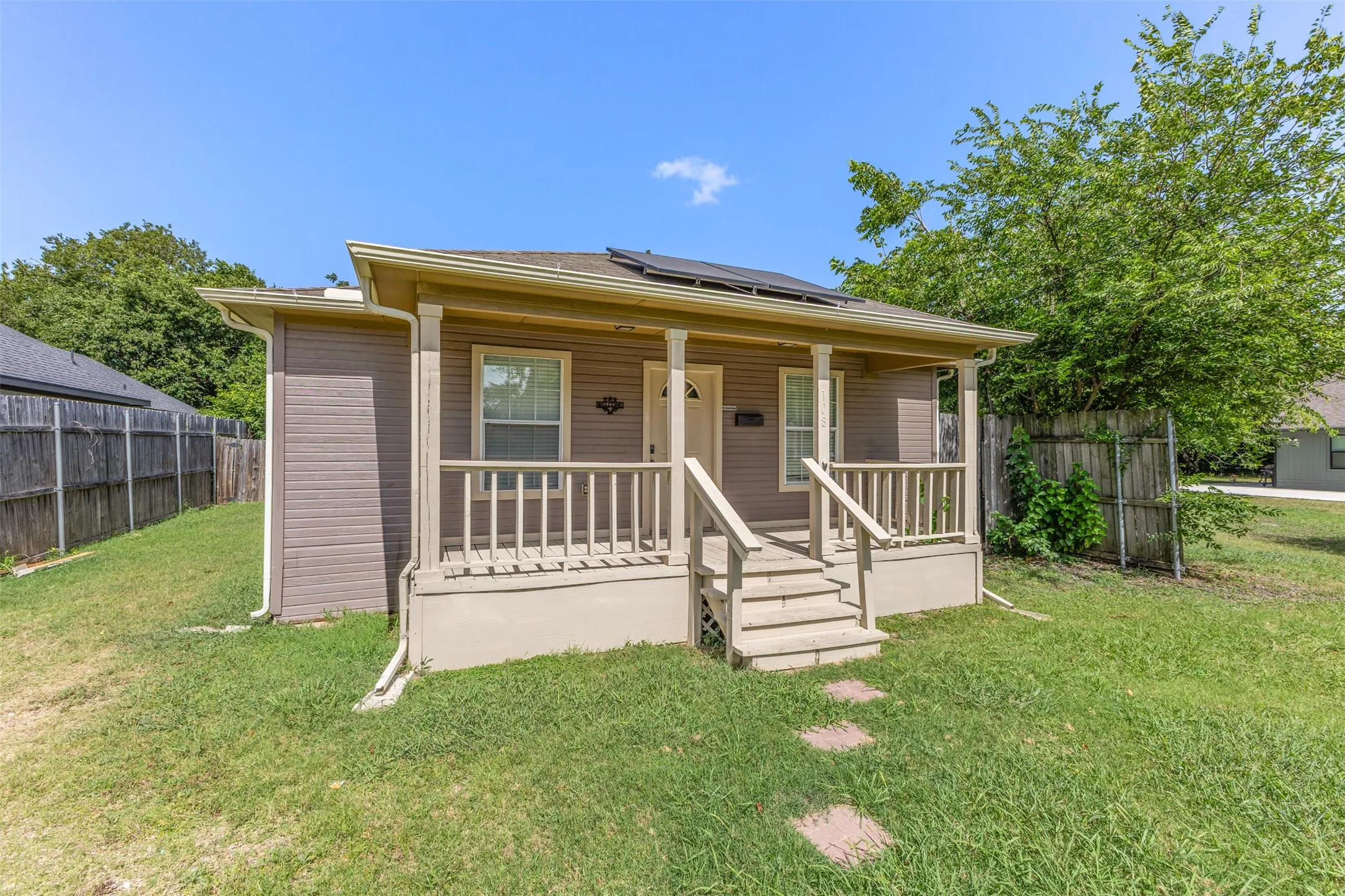 Exterior featuring horizontal siding, a covered front porch with railings, and a direct entry staircase