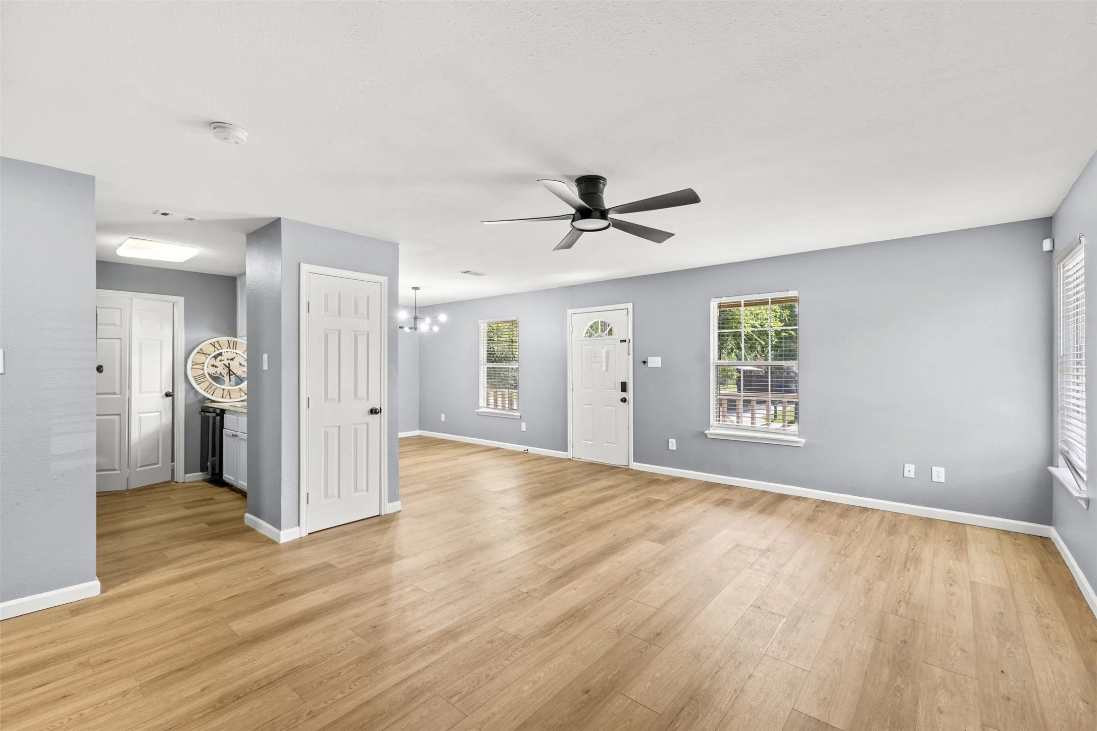 Open concept living space featuring wood-finish flooring throughout