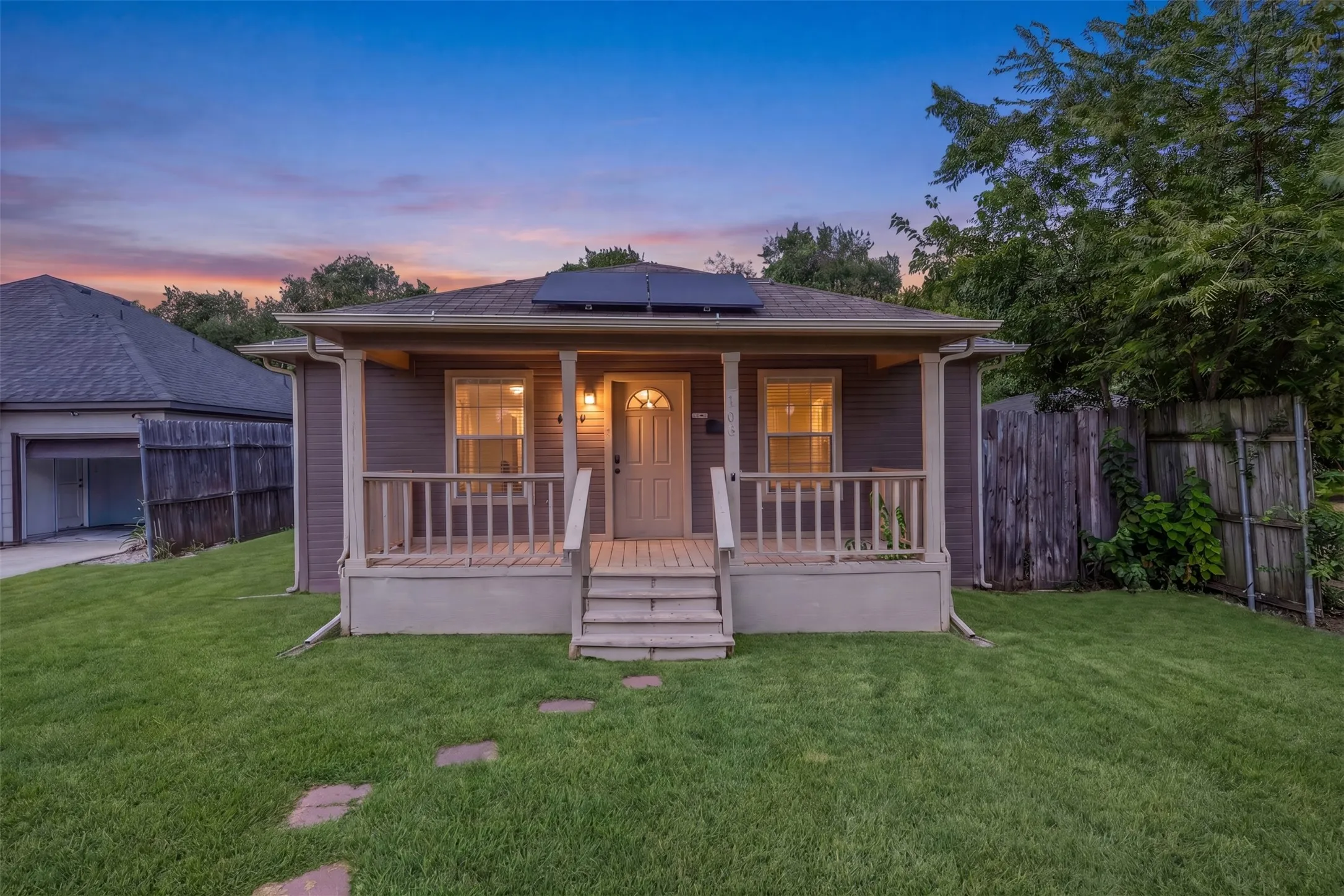 Charming single-story residence featuring a covered front porch with railings